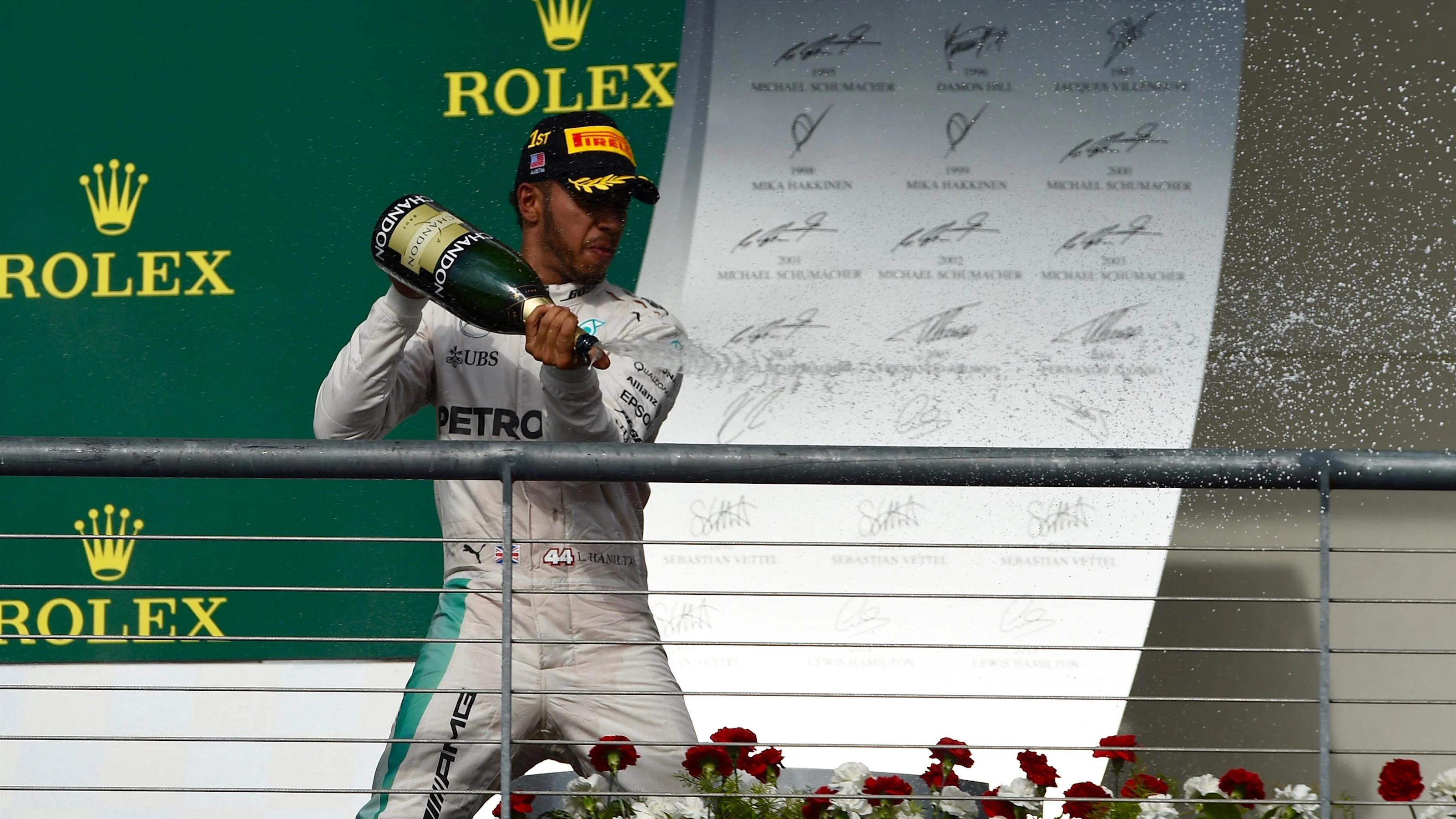 Race winner Lewis Hamilton (GBR) Mercedes AMG F1 celebrates on the podium with the champagne at
