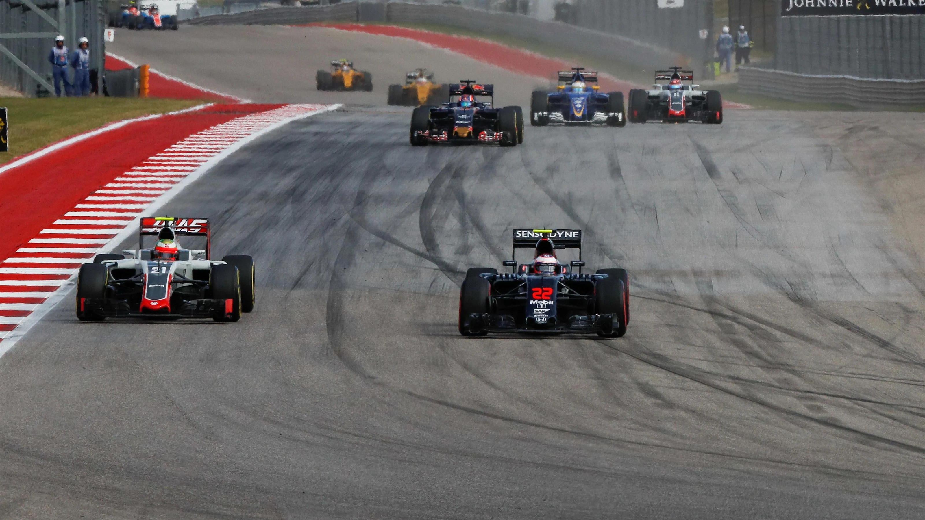 Jenson Button (GBR) McLaren MP4-31 battles for position with Esteban Gutierrez (MEX) Haas VF-16 at