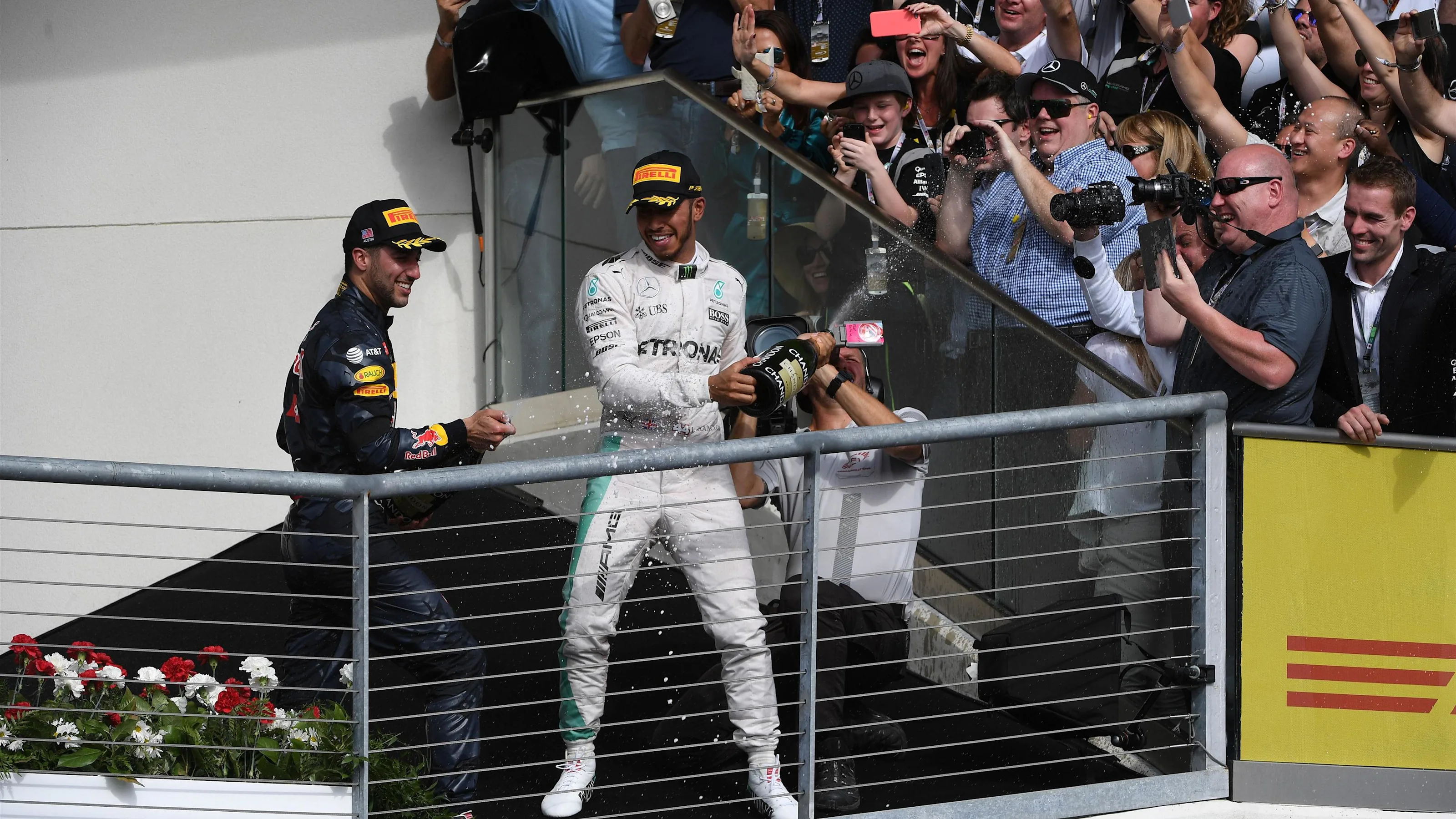 Lewis Hamilton (GBR) Mercedes AMG F1 and Daniel Ricciardo (AUS) Red Bull Racing celebrate on the