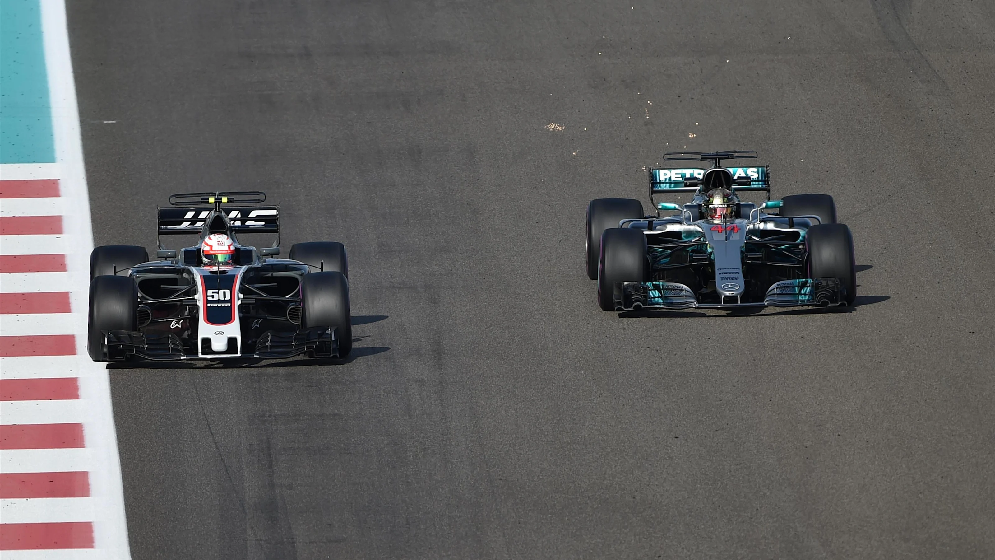 Antonio Giovinazzi (ITA) Haas VF-17 and Lewis Hamilton (GBR) Mercedes-Benz F1 W08 Hybrid at Formula