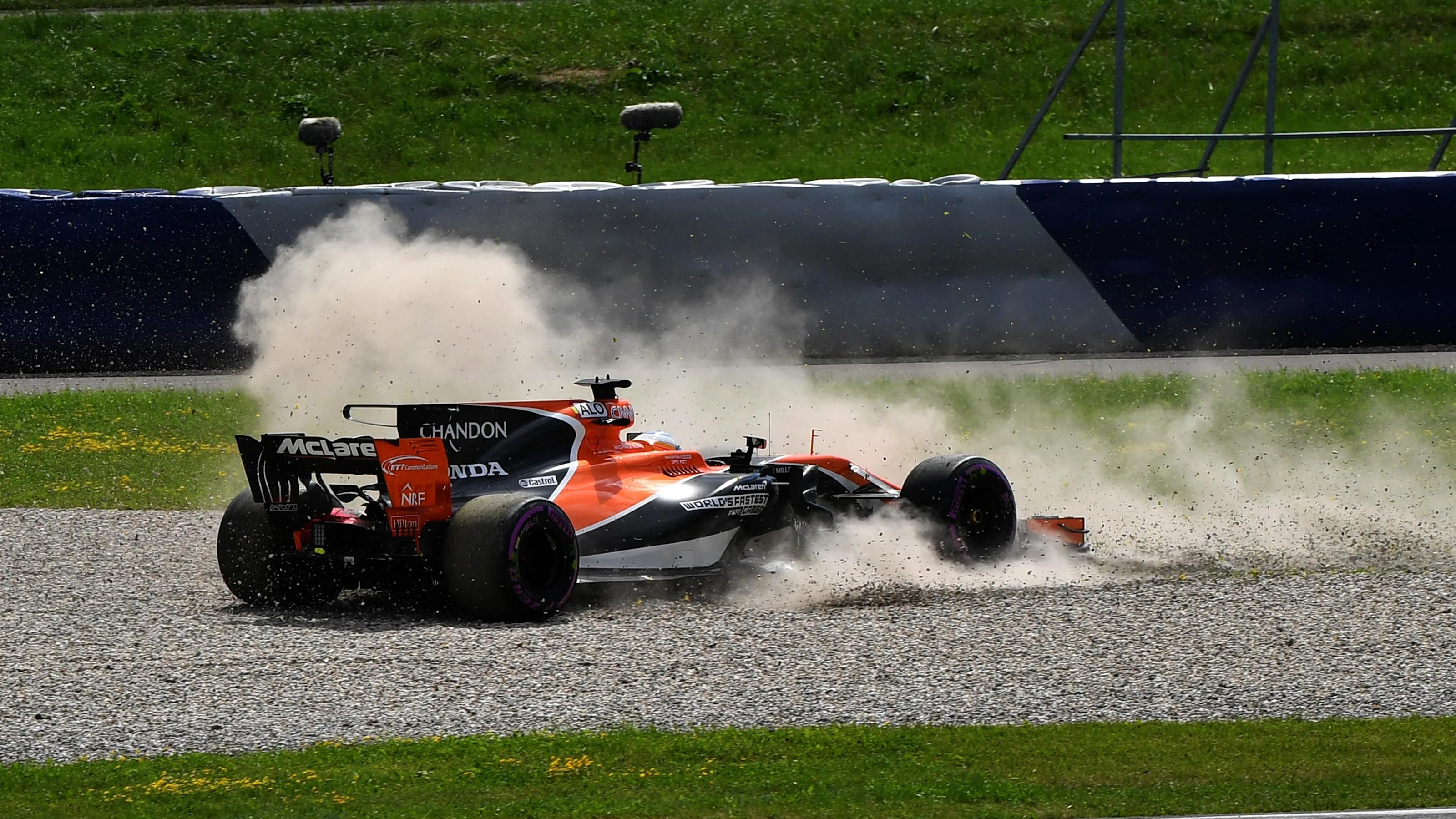 Fernando Alonso (ESP) McLaren MCL32 spins into the gravel at Formula One World Championship, Rd9,