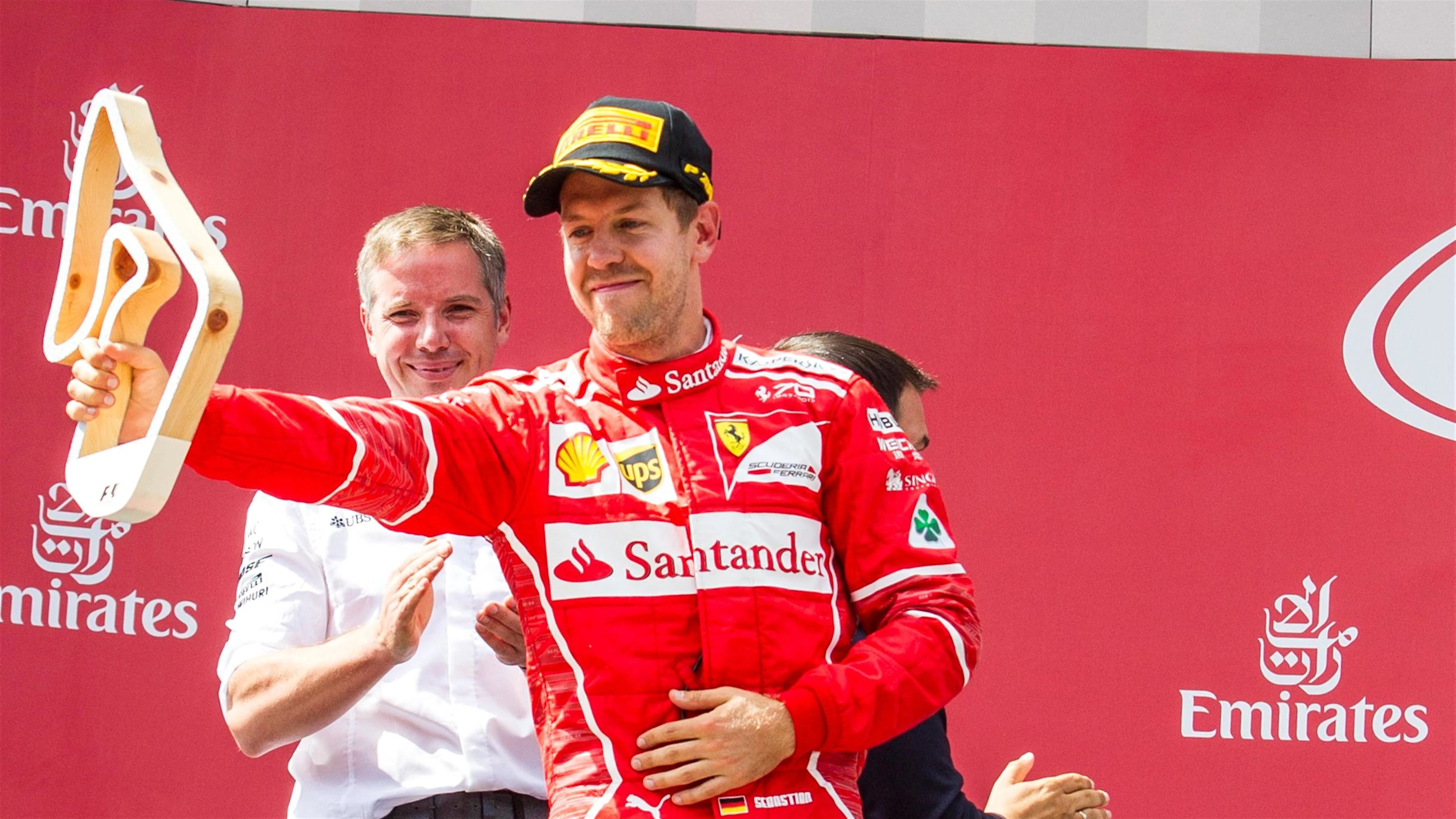 Sebastian Vettel (GER) Ferrari celebrates on the podium with the trophy at Formula One World
