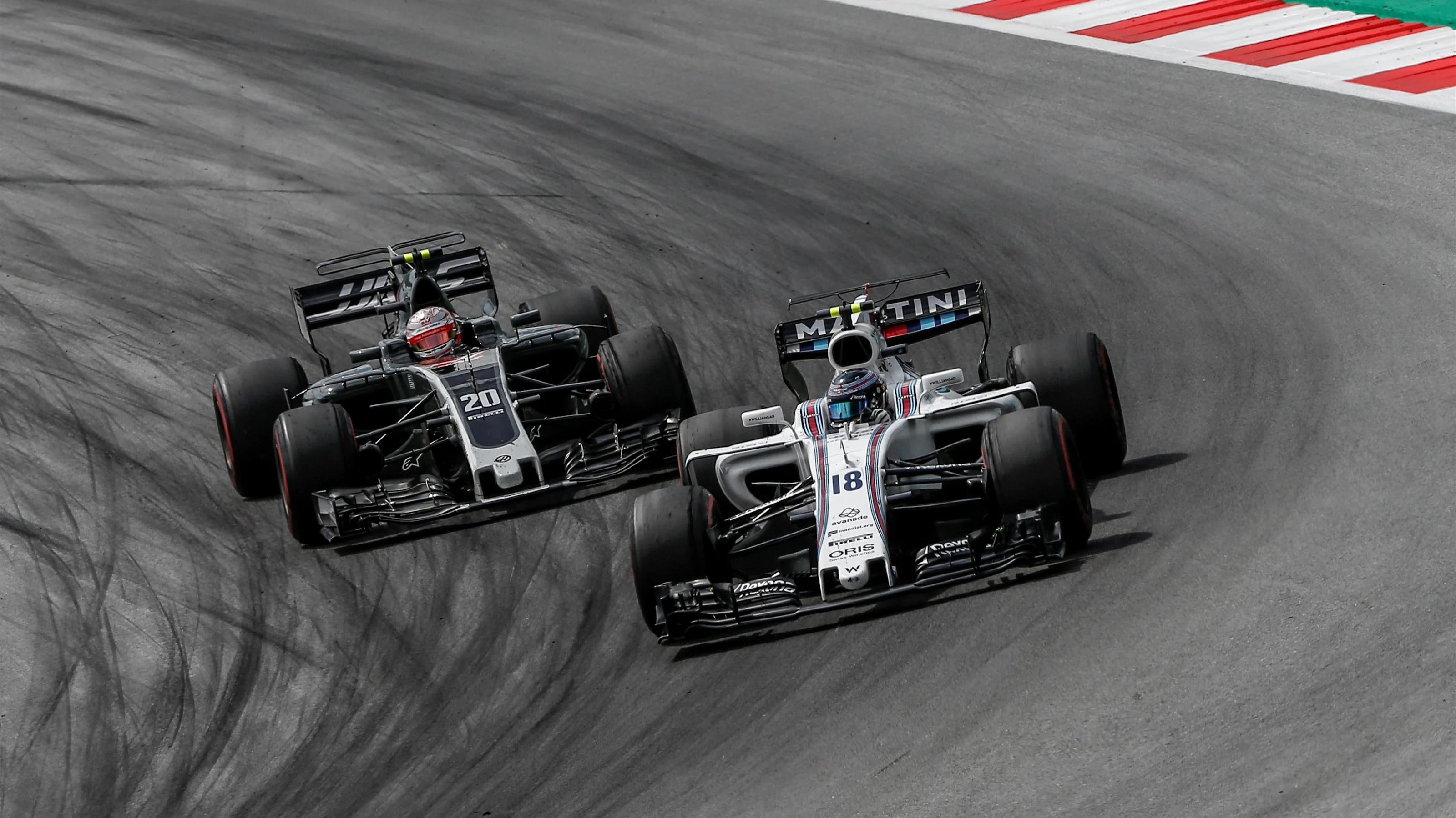 Lance Stroll (CDN) Williams FW40 and Kevin Magnussen (DEN) Haas VF-17 at Formula One World