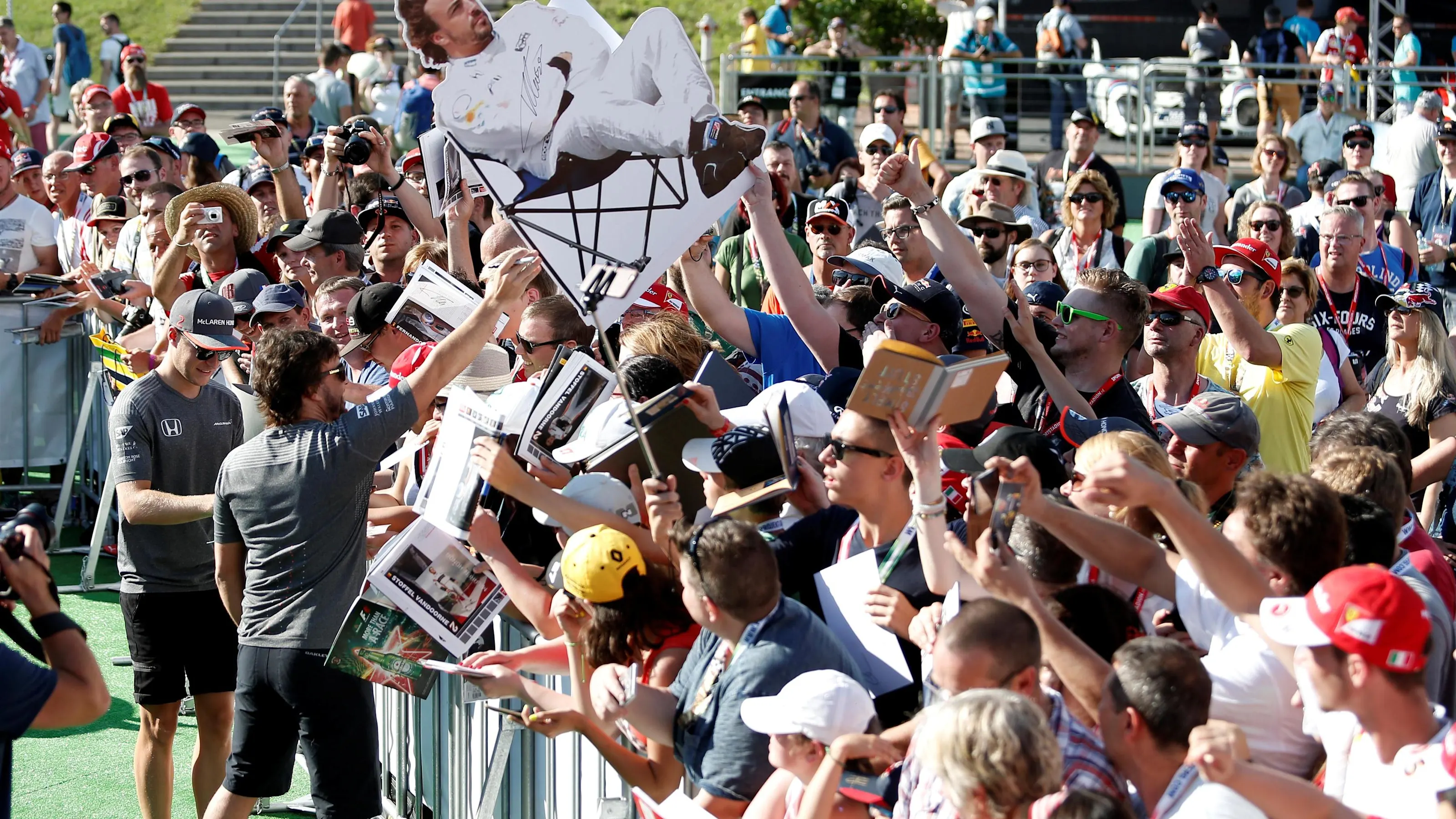 Stoffel Vandoorne (BEL) McLaren and Fernando Alonso (ESP) McLaren sign autographs for the fans at