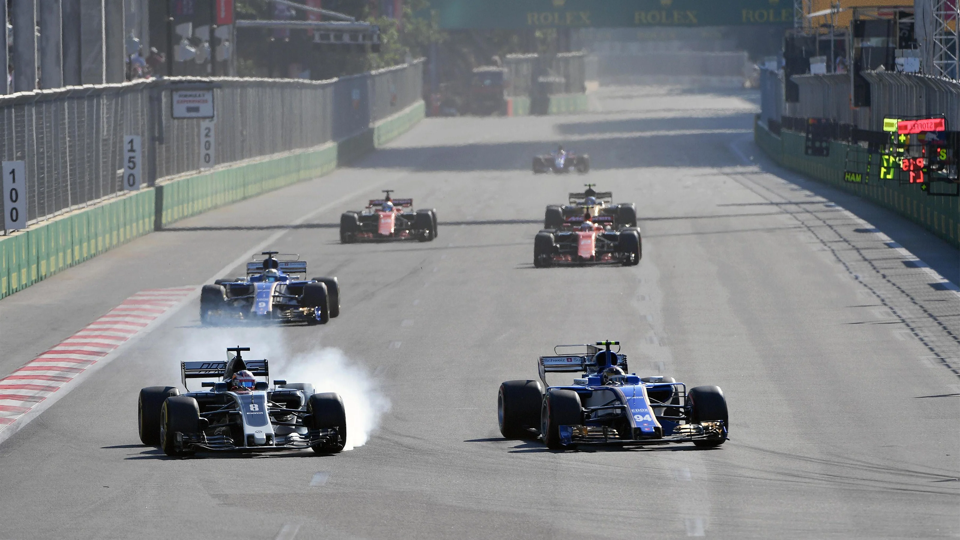 Romain Grosjean (FRA) Haas VF-17 locks up and battles with Pascal Wehrlein (GER) Sauber C36 at