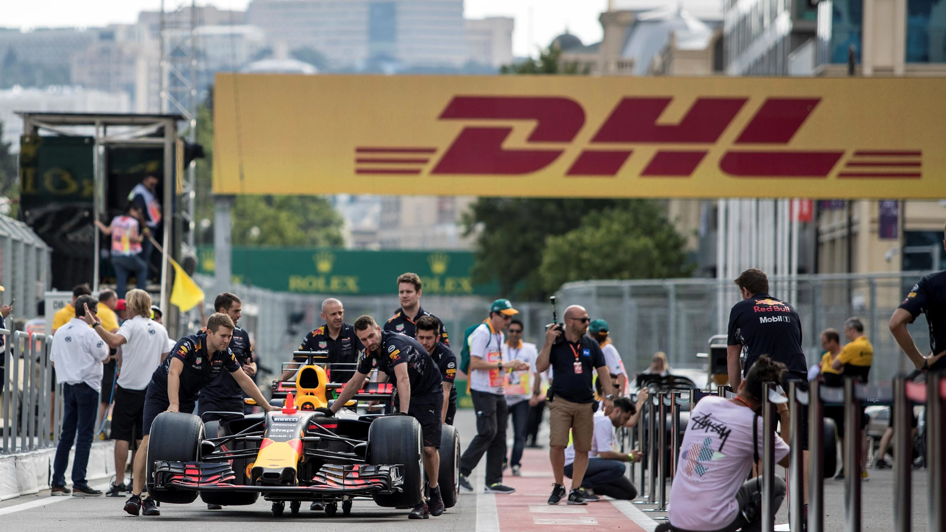 Red Bull Racing mechanics push the Red Bull Racing RB13 car in the pitalne at Formula One World