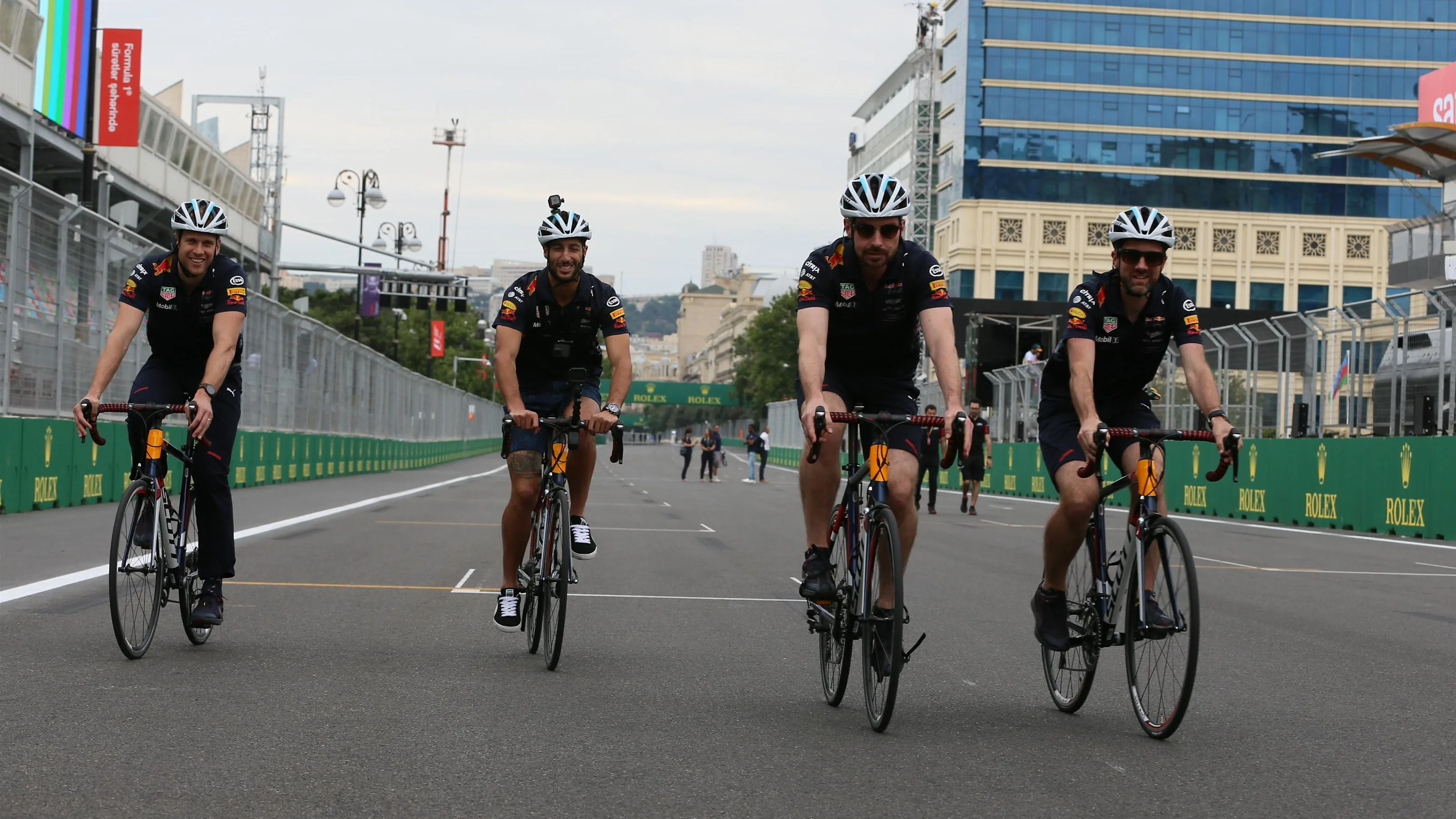 Daniel Ricciardo (AUS) Red Bull Racing rides a bicycle on track with the Red Bull Racing mechanics