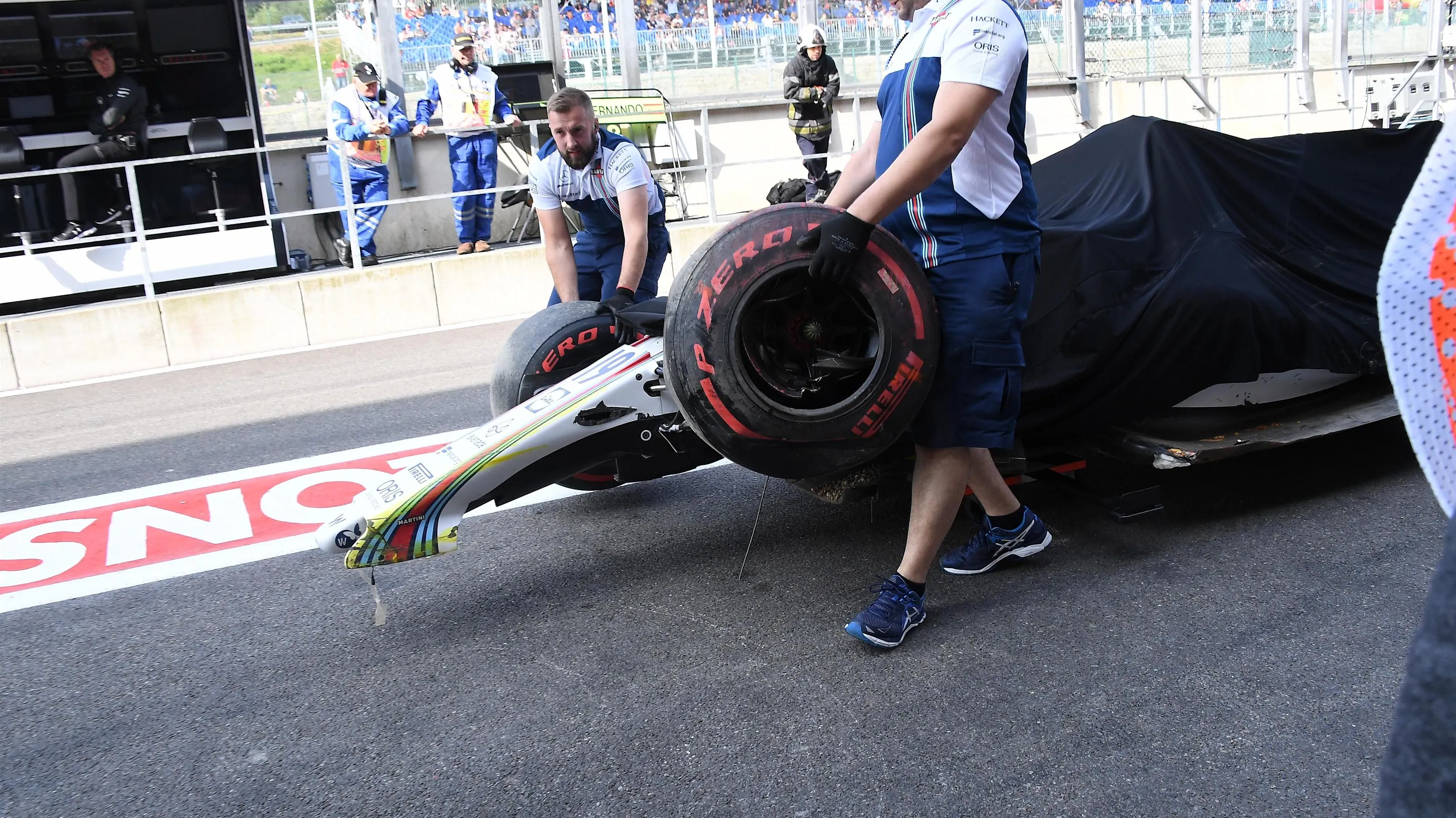 The crashed car of Felipe Massa (BRA) Williams FW40 is recovered in FP1 and pushed down pitlane by