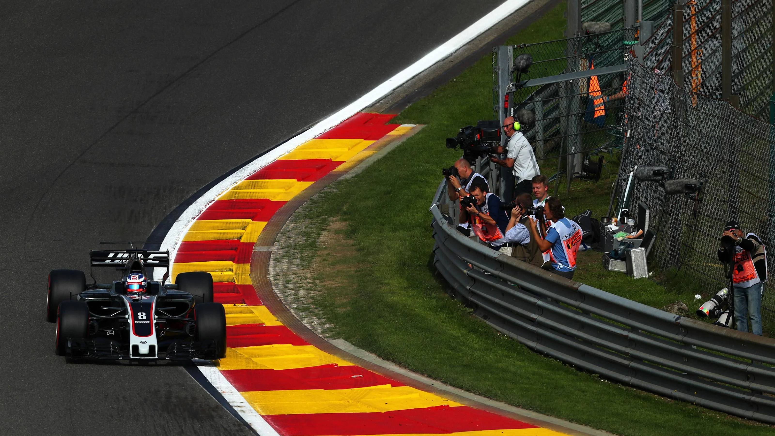 Romain Grosjean (FRA) Haas VF-17 and photographers at Formula One World Championship, Rd12, Belgian