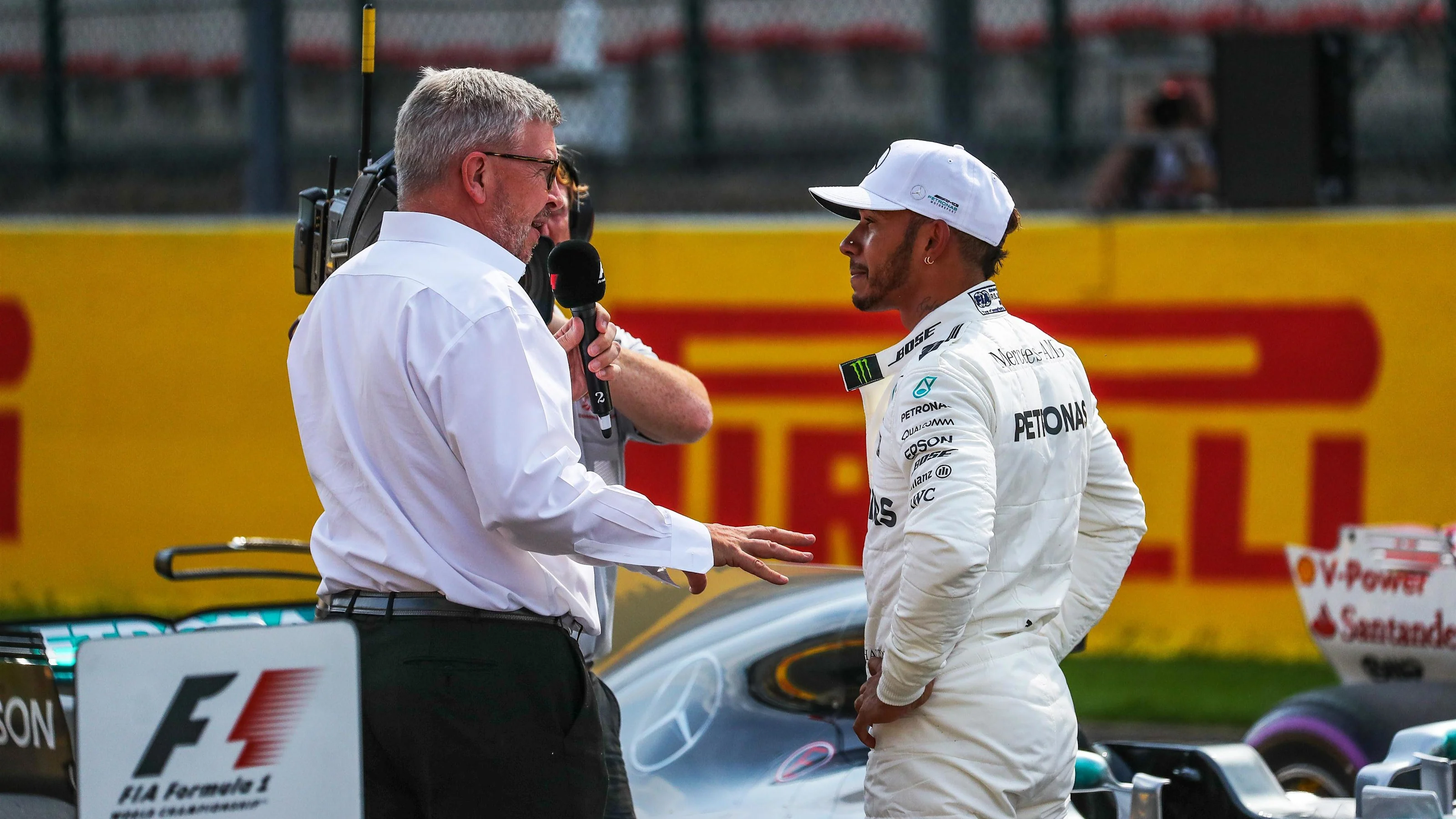 Ross Brawn (GBR) Formula One Managing Director of Motorsports and pole sitter Lewis Hamilton (GBR)
