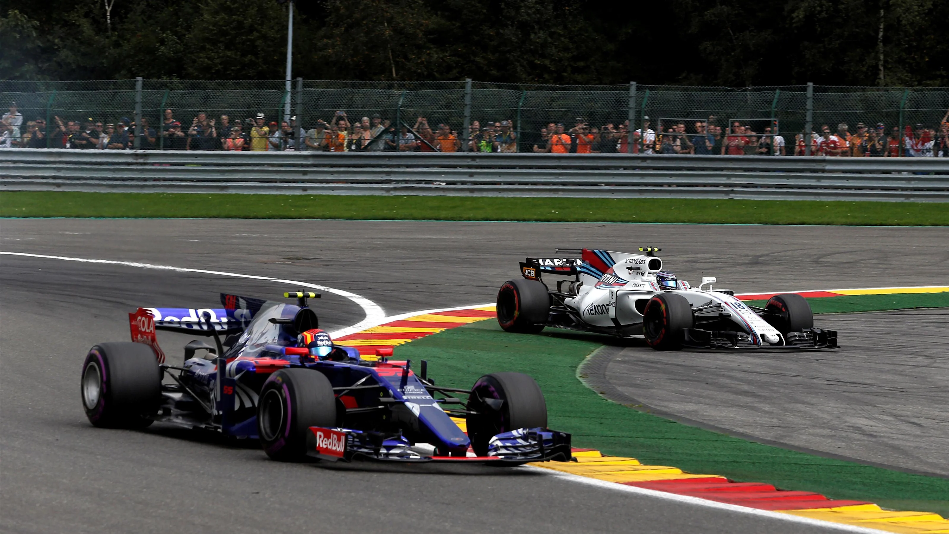 Lance Stroll (CDN) Williams FW40 runs wide alongside Carlos Sainz jr (ESP) Scuderia Toro Rosso