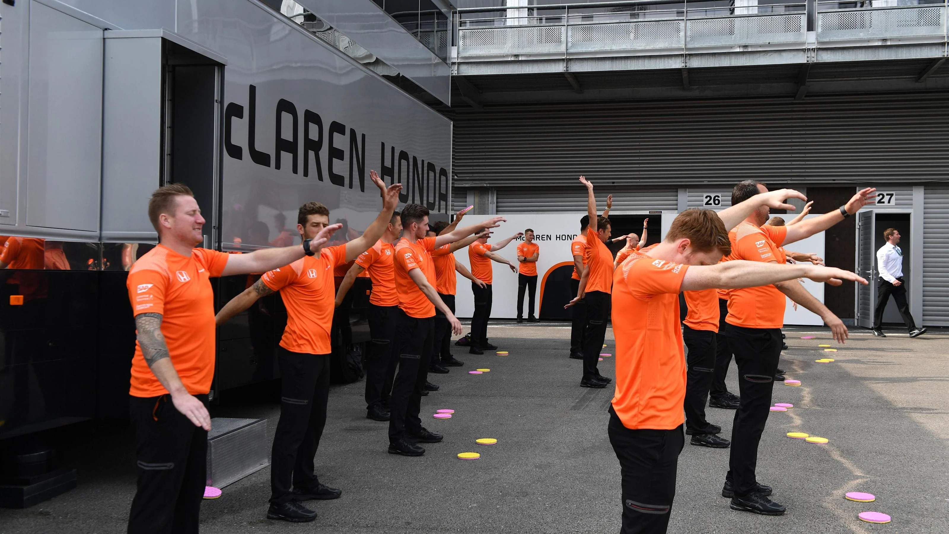McLaren mechanics warm up excercise at Formula One World Championship, Rd12, Belgian Grand Prix,
