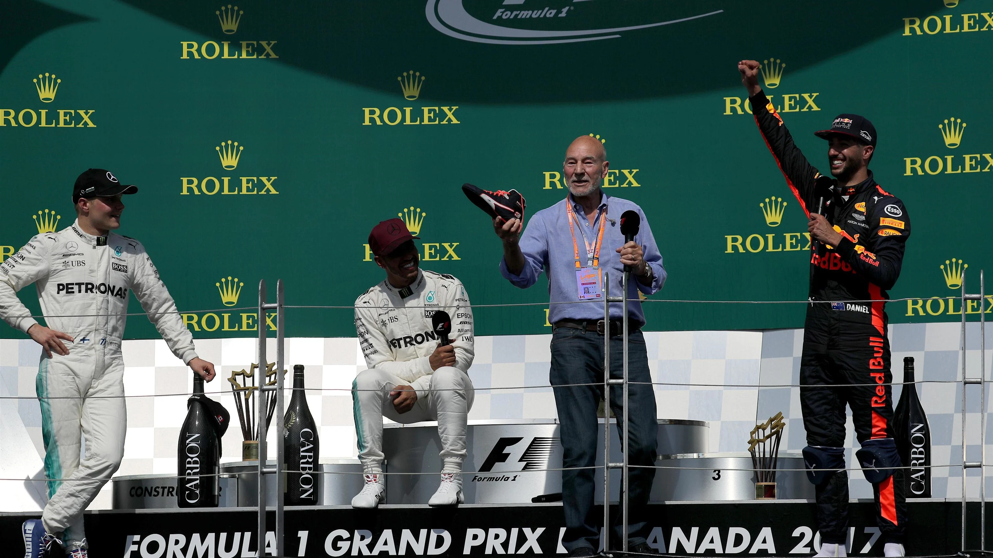Patrick Stewart (GBR) Actor celebrates and drinks from the boot of Daniel Ricciardo (AUS) Red Bull
