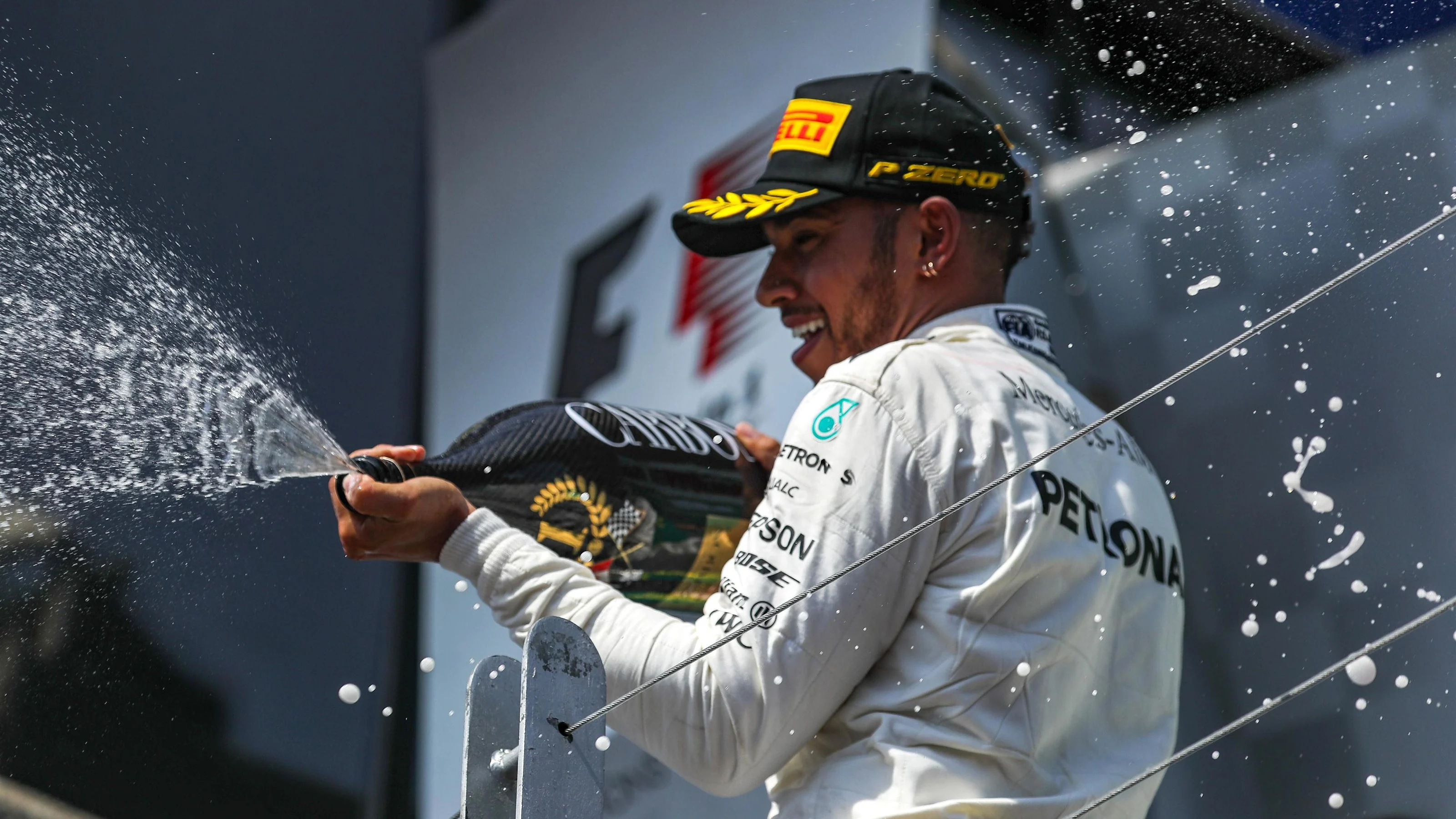 Race winner Lewis Hamilton (GBR) Mercedes AMG F1 celebrates on the podium with the champagne at