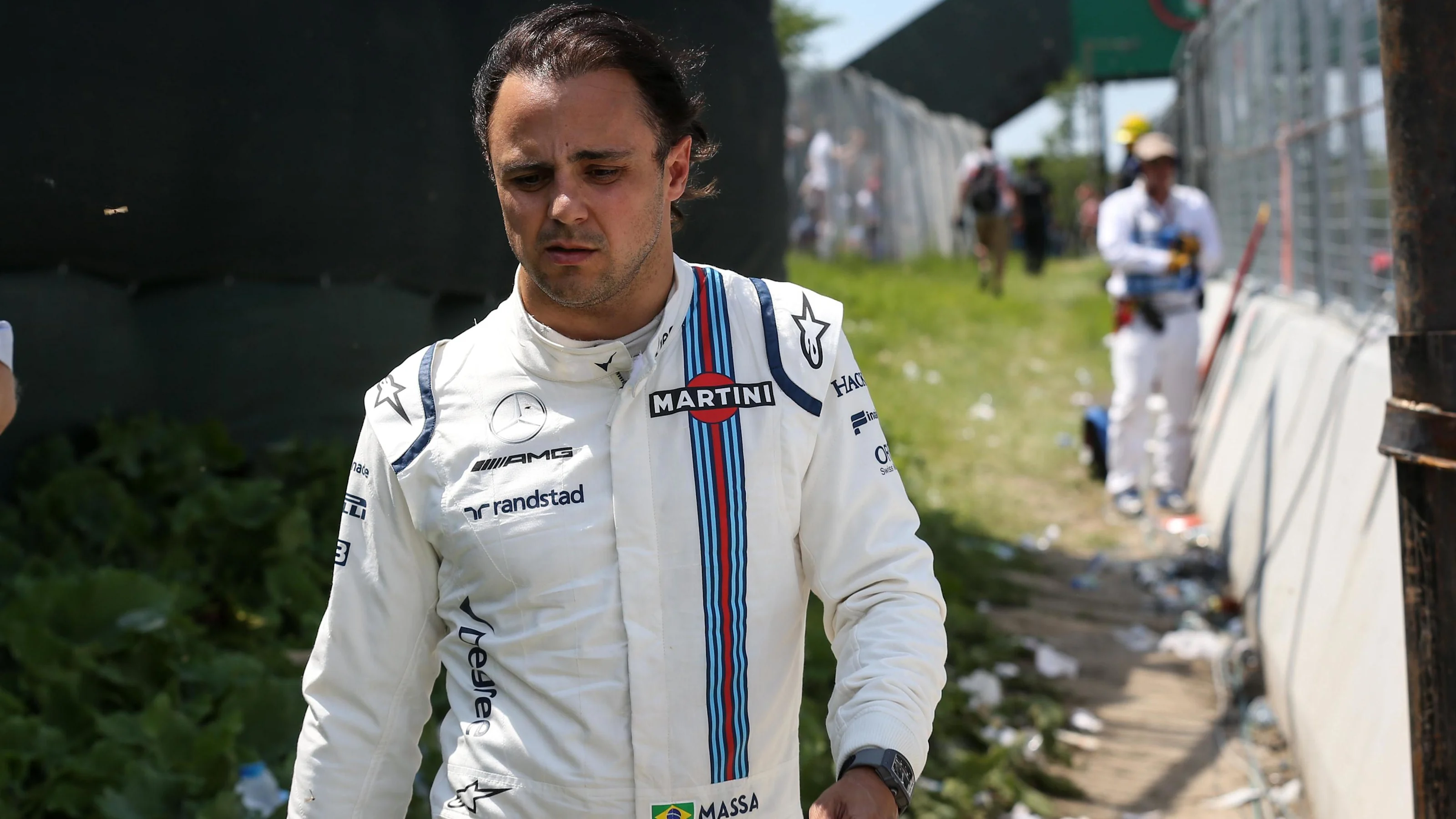 Race retiree Felipe Massa (BRA) Williams walks back after after crashing out of the race at Formula