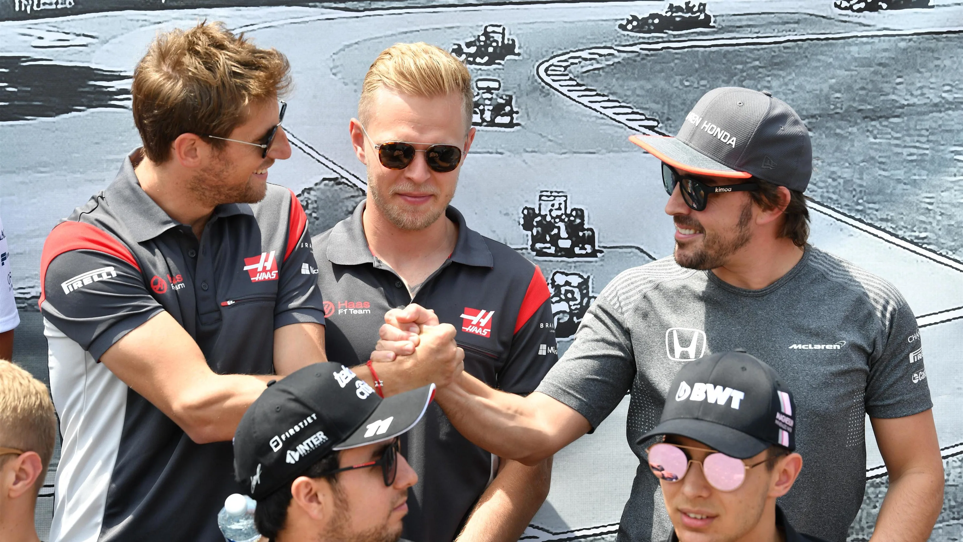 Romain Grosjean (FRA) Haas F1, Kevin Magnussen (DEN) Haas F1 and Fernando Alonso (ESP) McLaren at