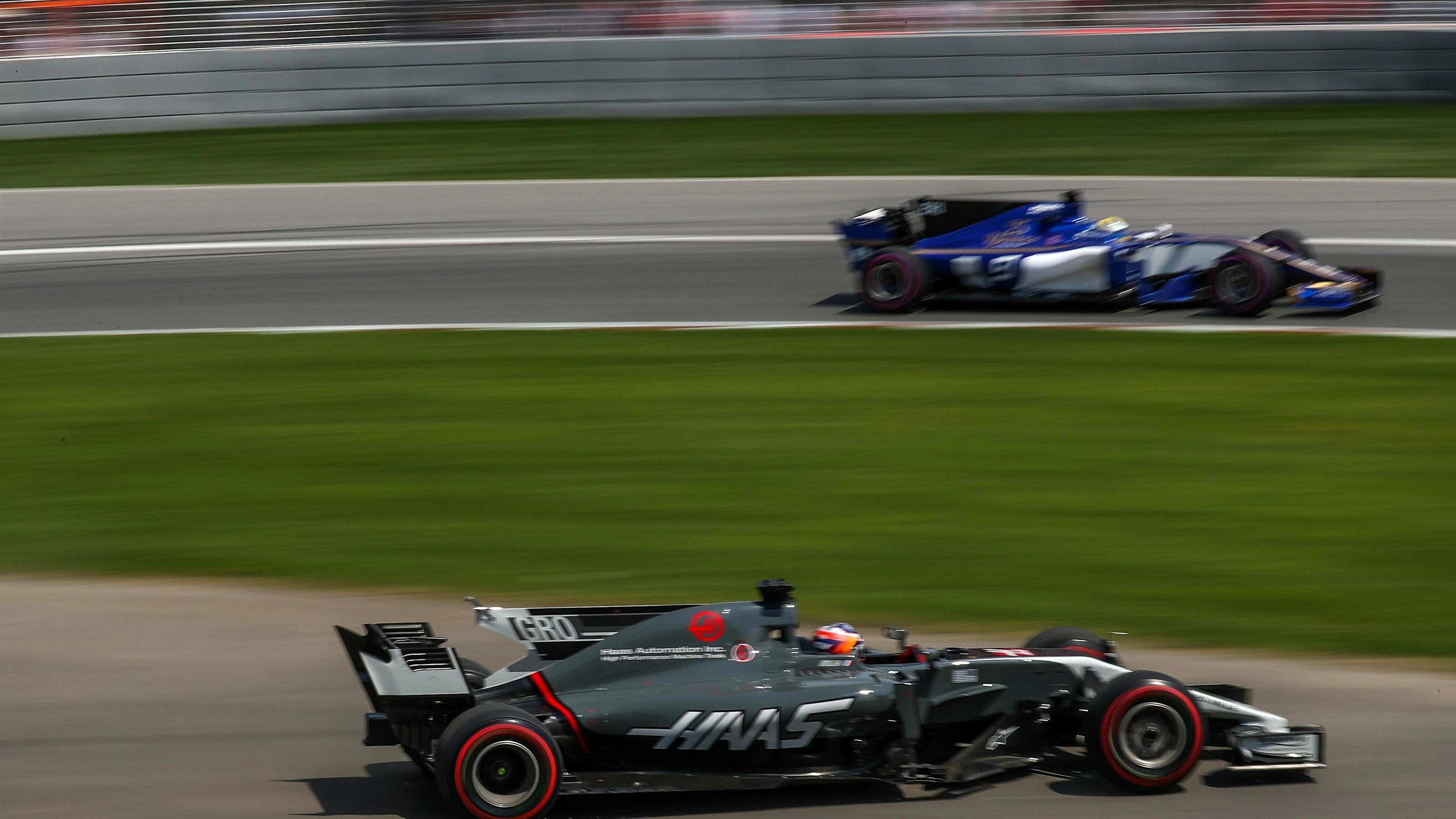 Romain Grosjean (FRA) Haas VF-17 and Marcus Ericsson (SWE) Sauber C36 at Formula One World