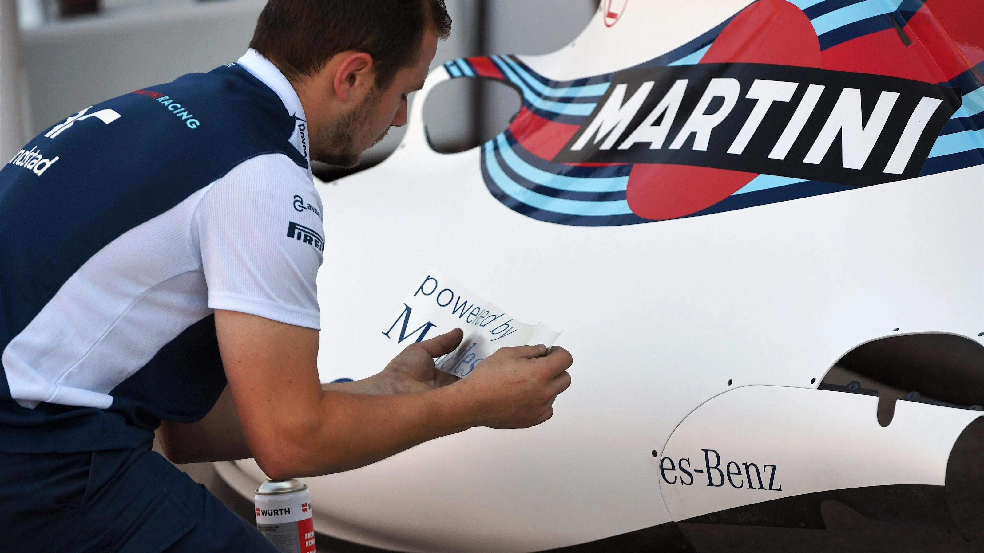 Williams mechanic applies logos to Williams FW40 bodywork at Formula One World Championship, Rd7,