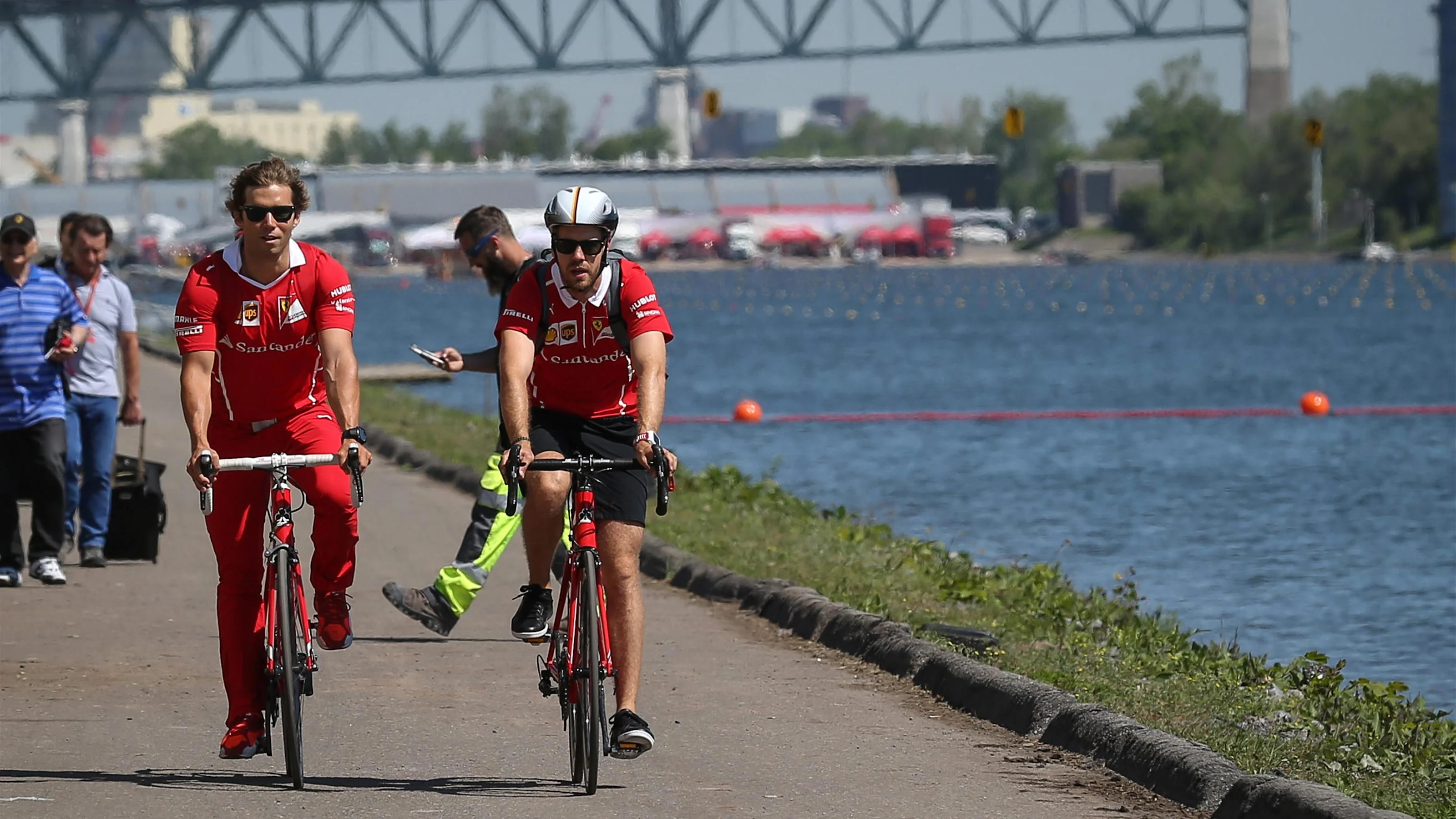Sebastian Vettel (GER) Ferrari with his trainer Antti Kontsas (FIN) on a bike at Formula One World