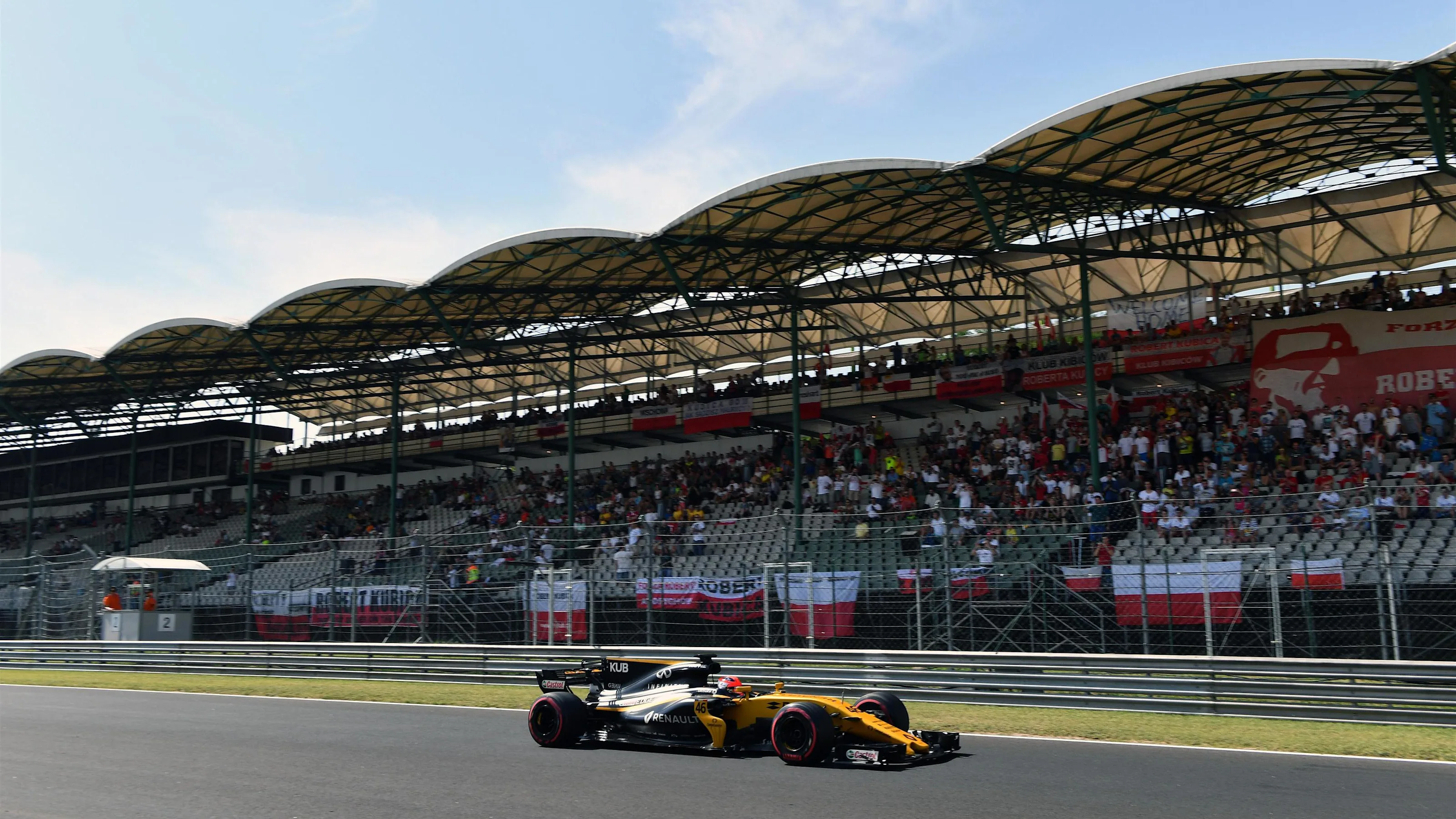 Robert Kubica (POL) Renault Sport F1 Team RS17 passes fans and banners at Formula One Testing, Day