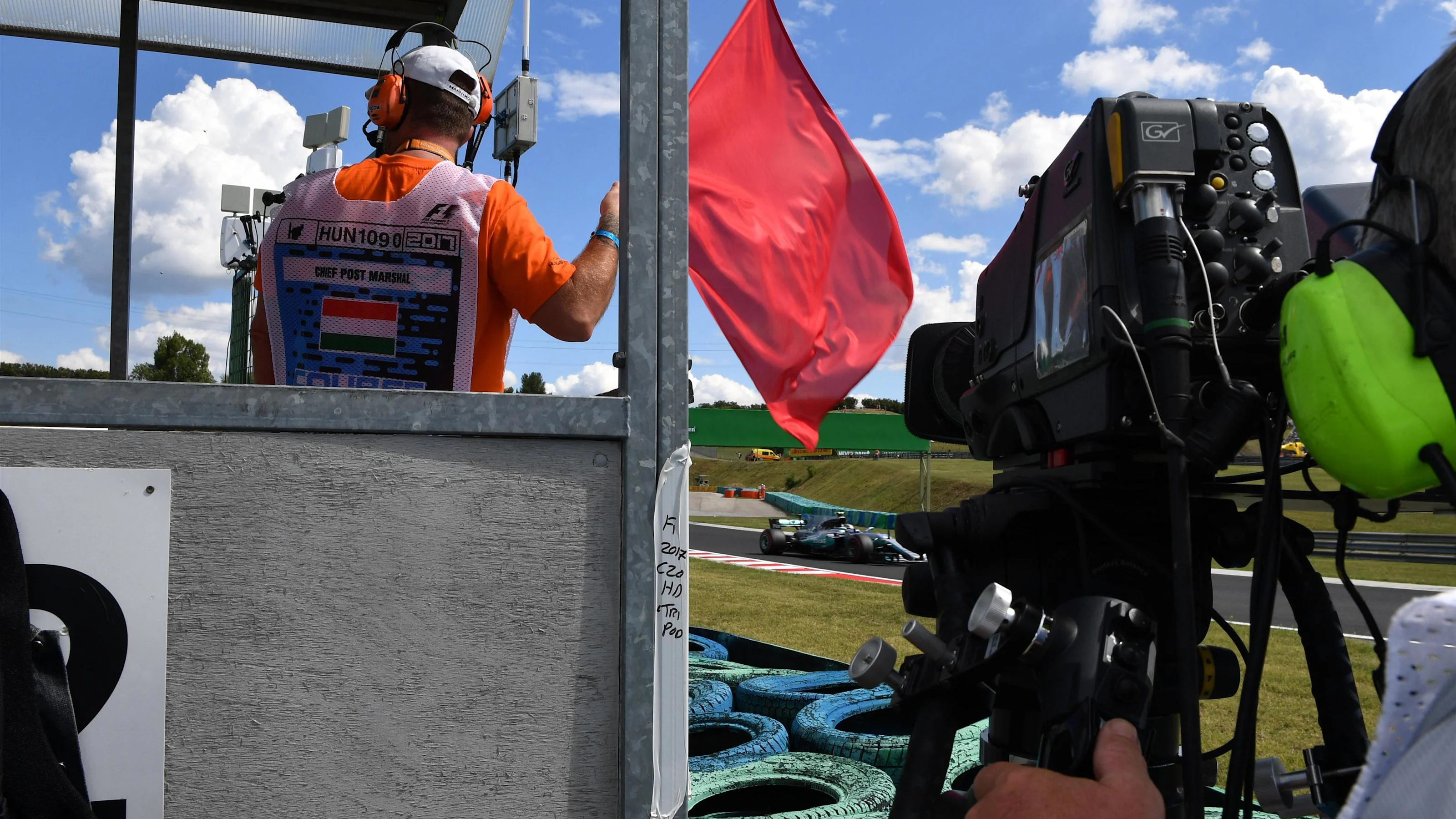 Marshal waves the red flag at Formula One World Championship, Rd11, Hungarian Grand Prix, Practice,