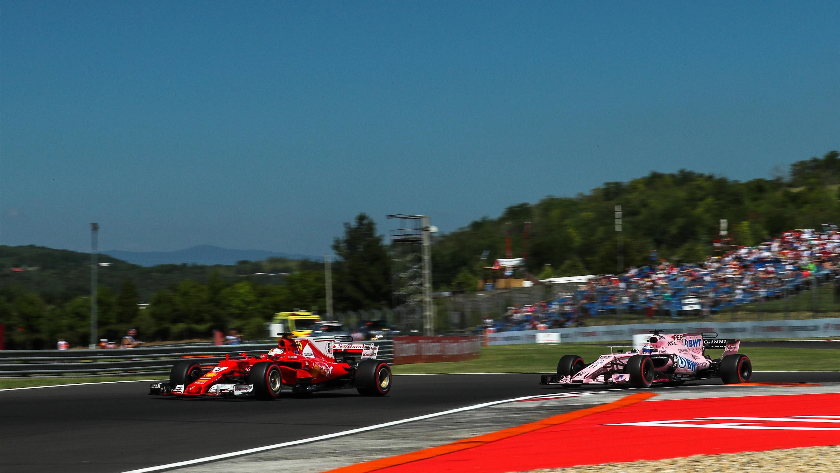 Sebastian Vettel (GER) Ferrari SF70-H and Sergio Perez (MEX) Force India VJM10 at Formula One World