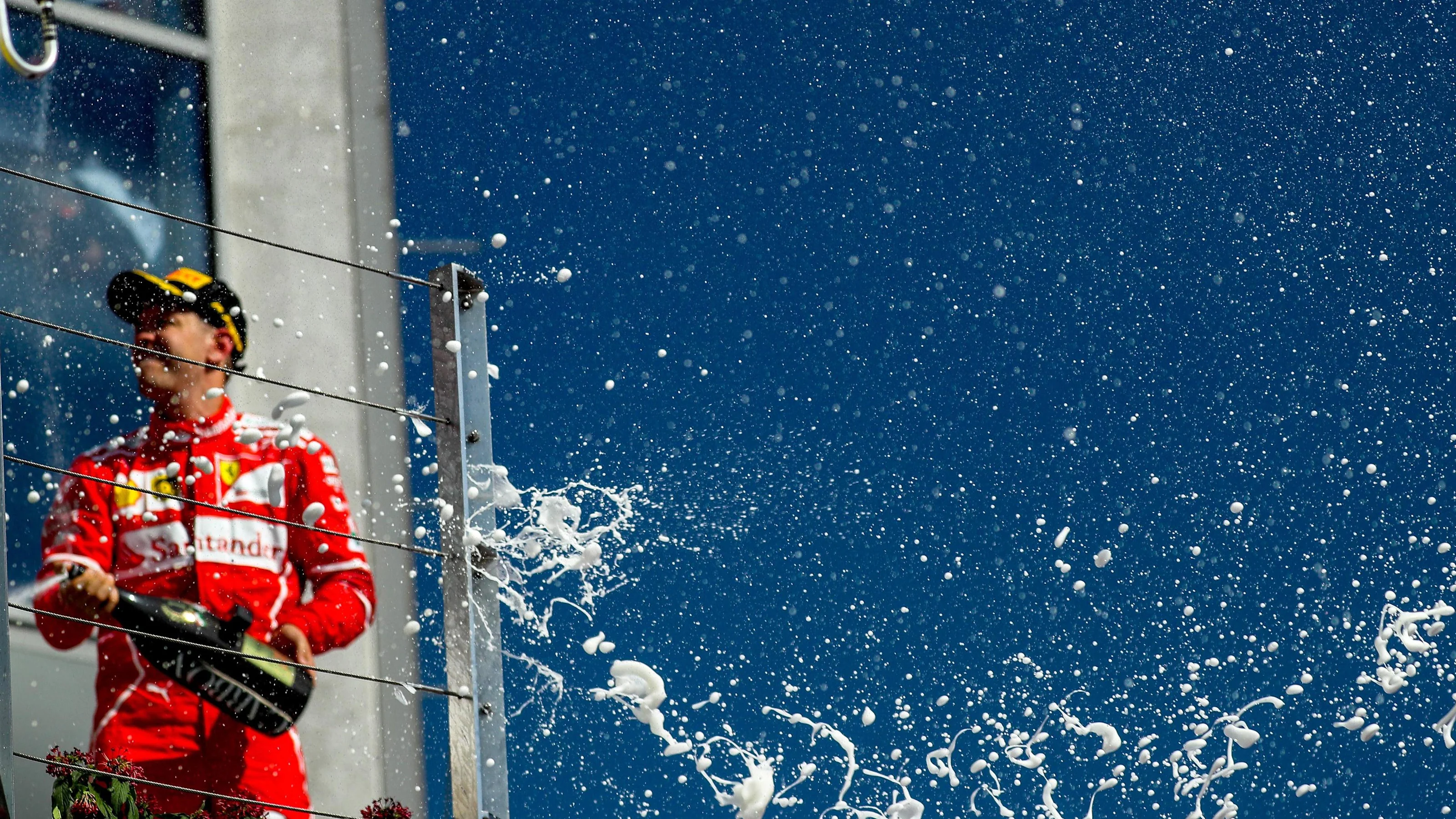 Race winner Sebastian Vettel (GER) Ferrari celebrates on the podium with the champagne at Formula