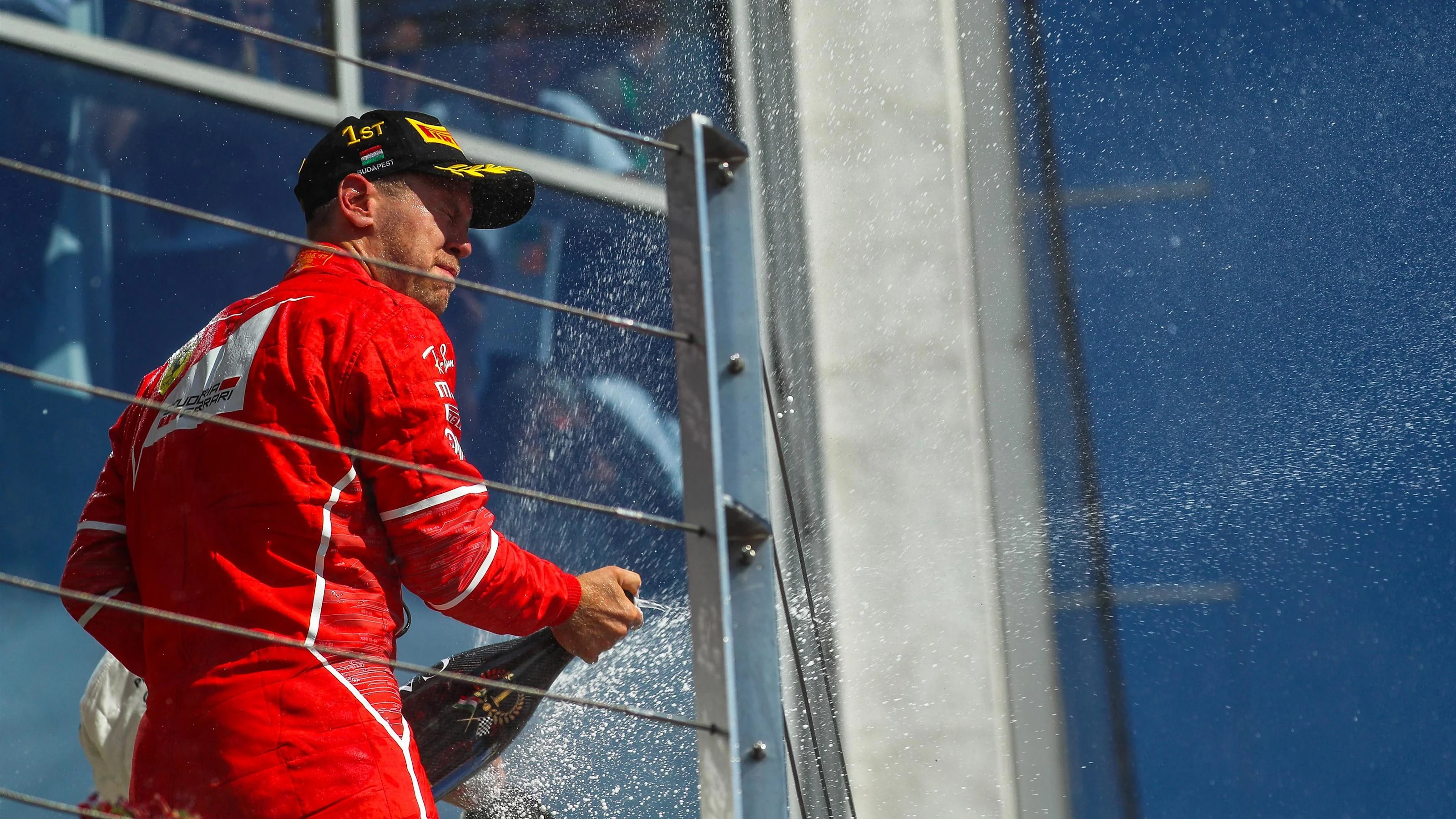 Race winner Sebastian Vettel (GER) Ferrari celebrates on the podium with the champagne at Formula