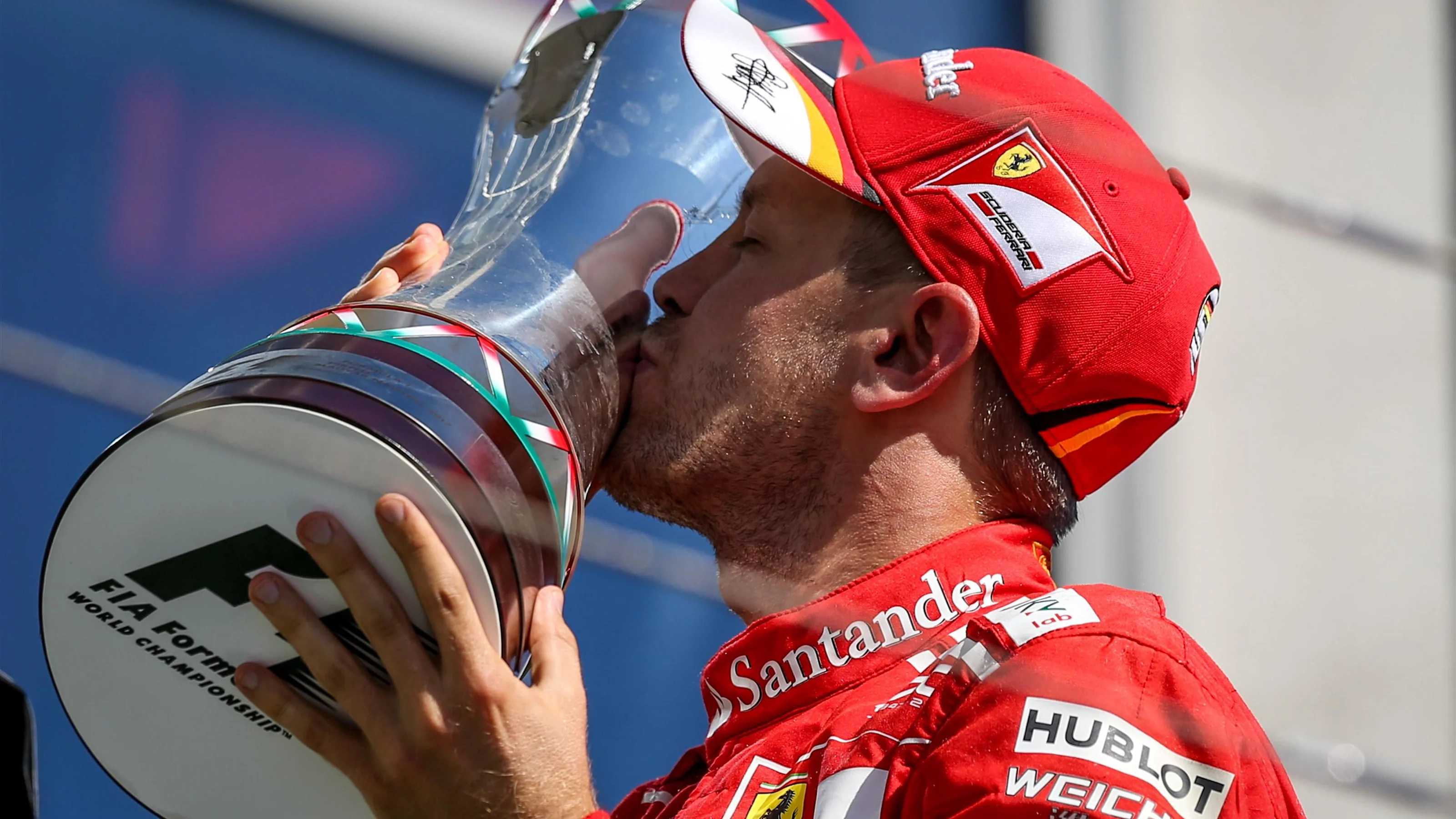 Race winner Sebastian Vettel (GER) Ferrari celebrates on the podium with the trophy at Formula One