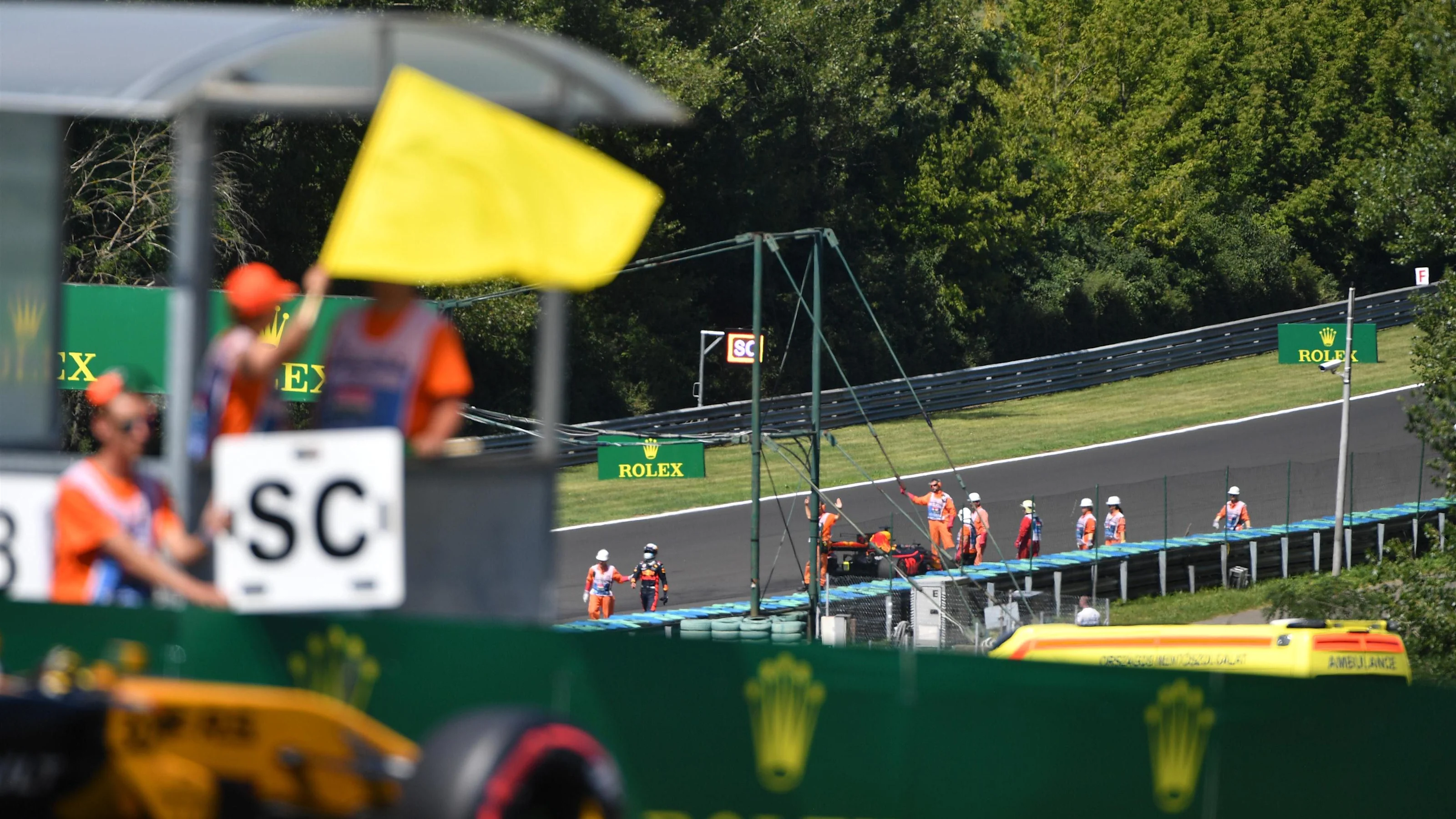 Yellow flag is waved with race retiree Daniel Ricciardo (AUS) Red Bull Racing RB13 in the