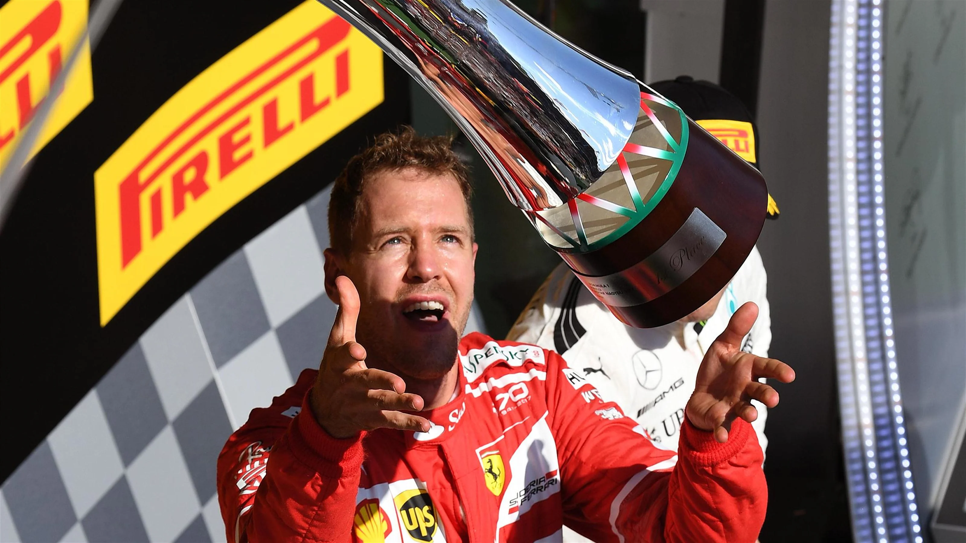 Race winner Sebastian Vettel (GER) Ferrari celebrates on the podium with the trophy at Formula One