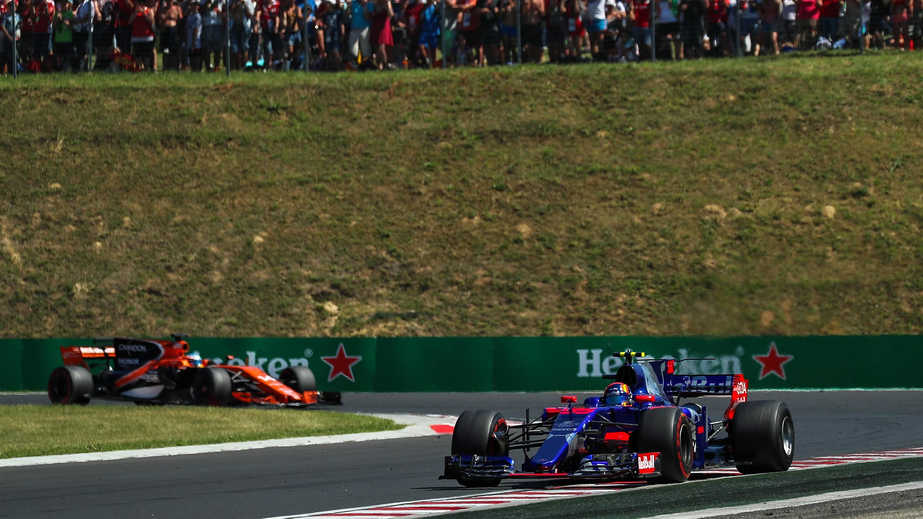 Carlos Sainz jr (ESP) Scuderia Toro Rosso STR12 leads Fernando Alonso (ESP) McLaren MCL32 at