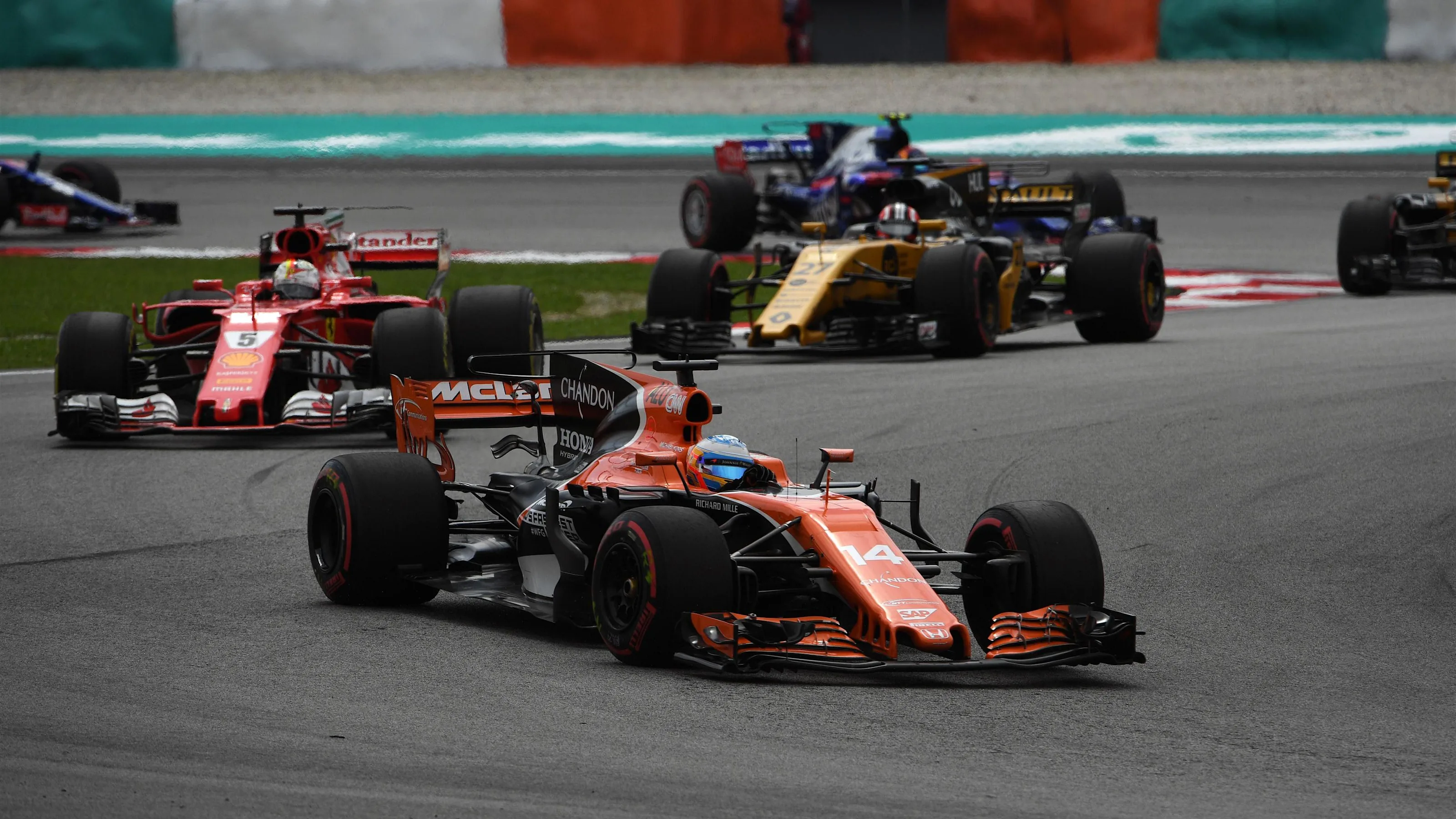 Fernando Alonso (ESP) McLaren MCL32 leads Sebastian Vettel (GER) Ferrari SF70-H at Formula One