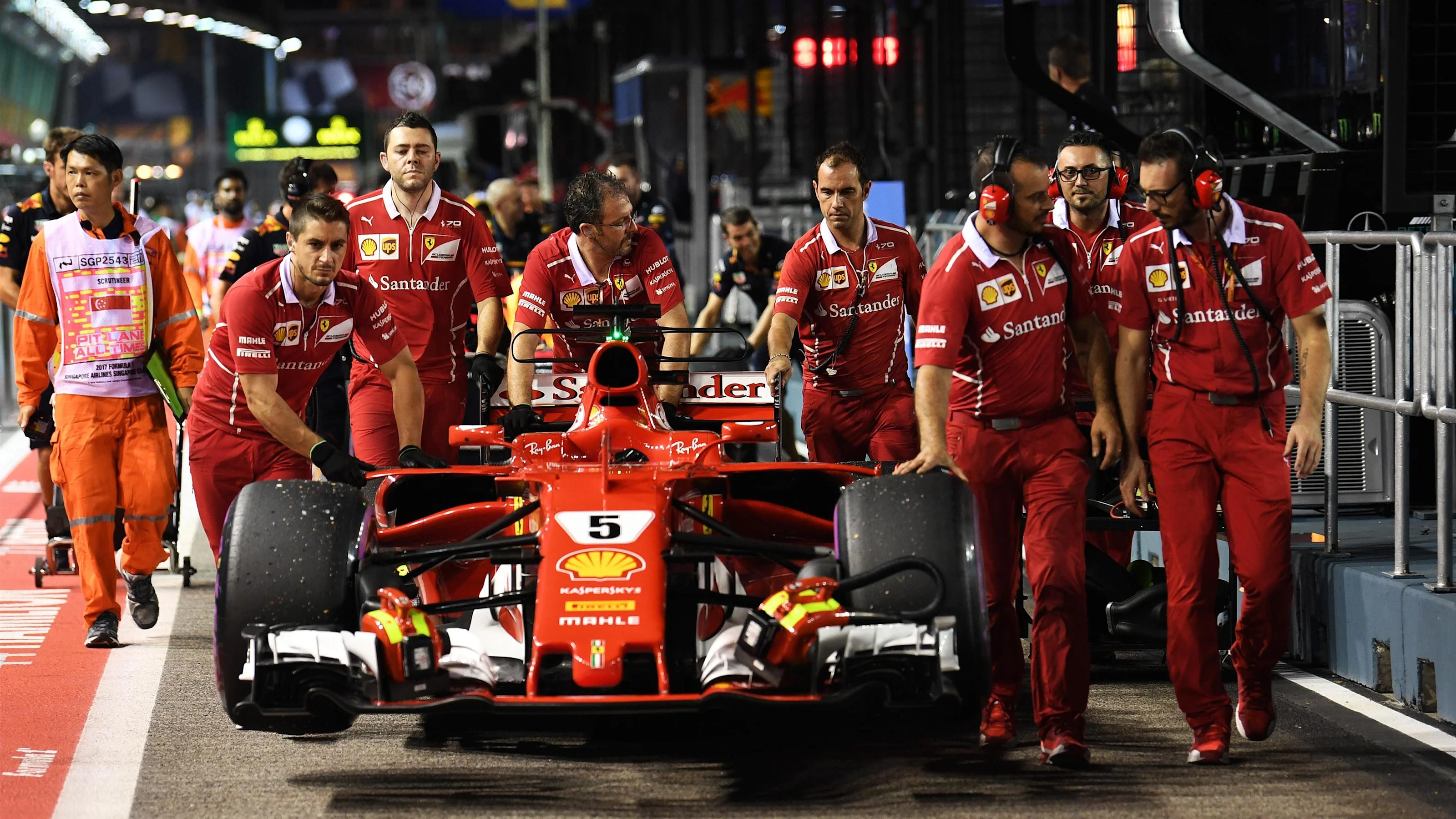 Ferrari mechanics with Ferrari SF70-H in pit lane at Formula One World Championship, Rd14,