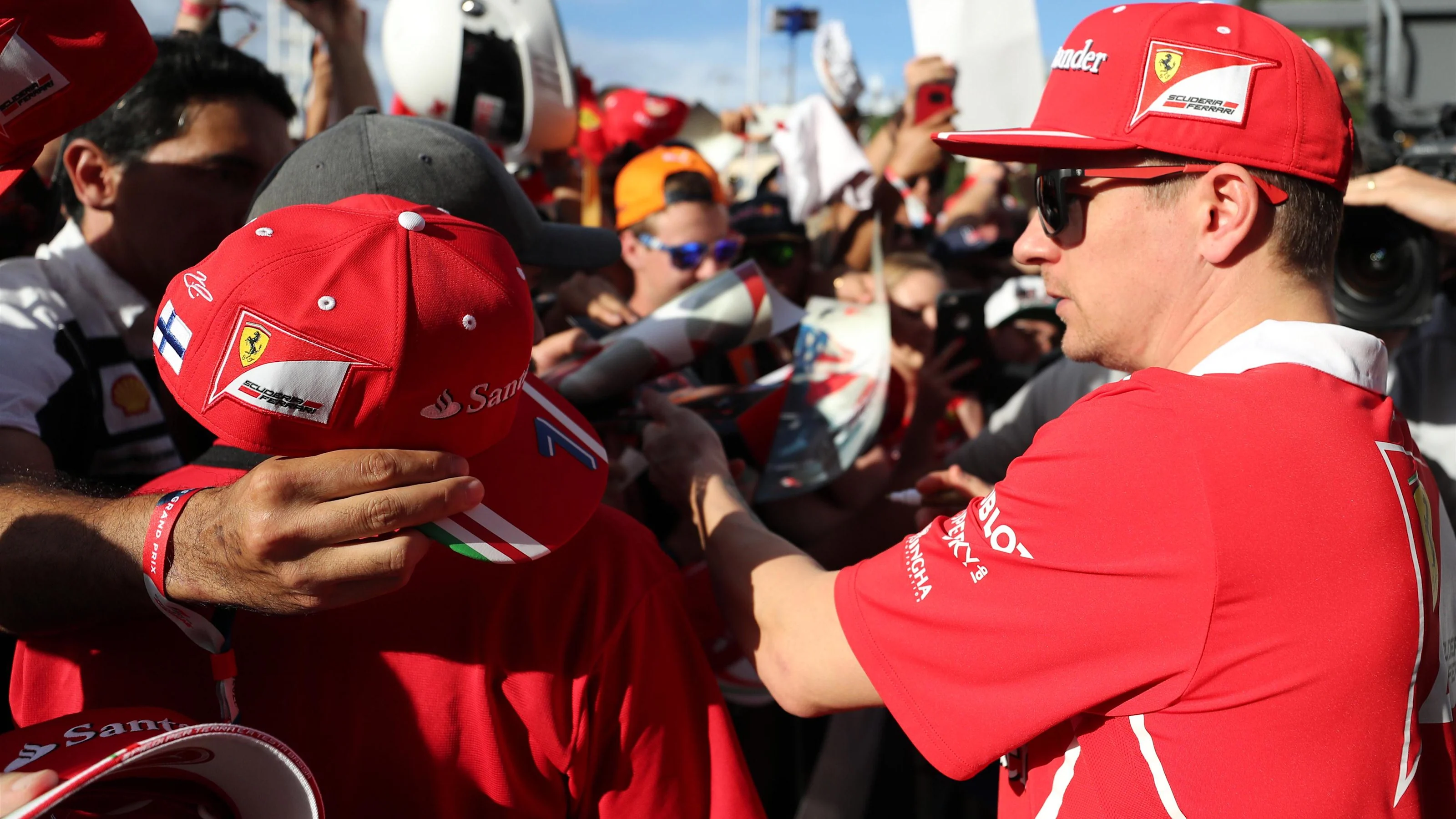 Kimi Raikkonen (FIN) Ferrari signs autographs for the fans at the autograph session at Formula One