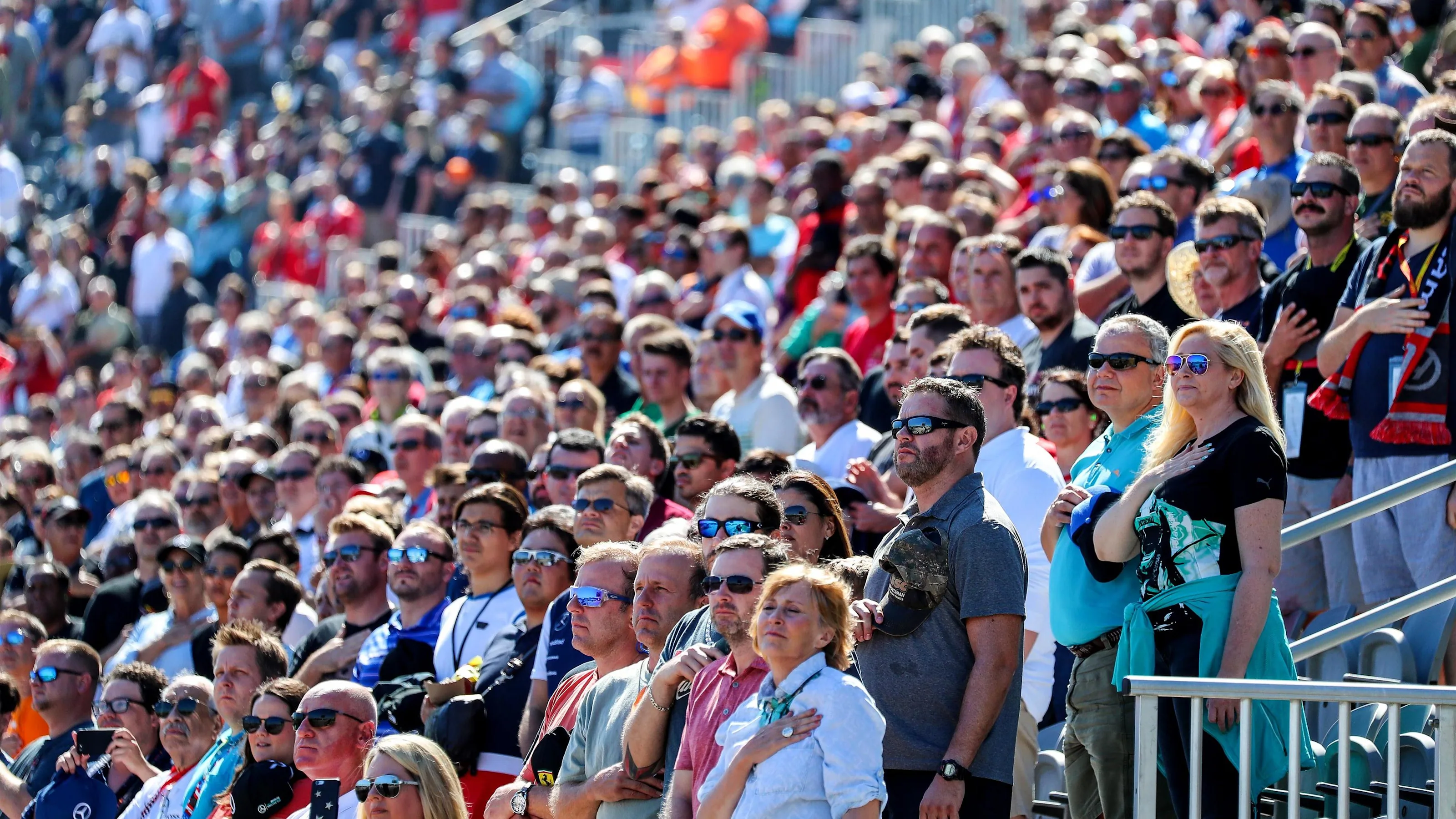Fans in the grandstand observe the National Anthem at Formula One World Championship, Rd17, United