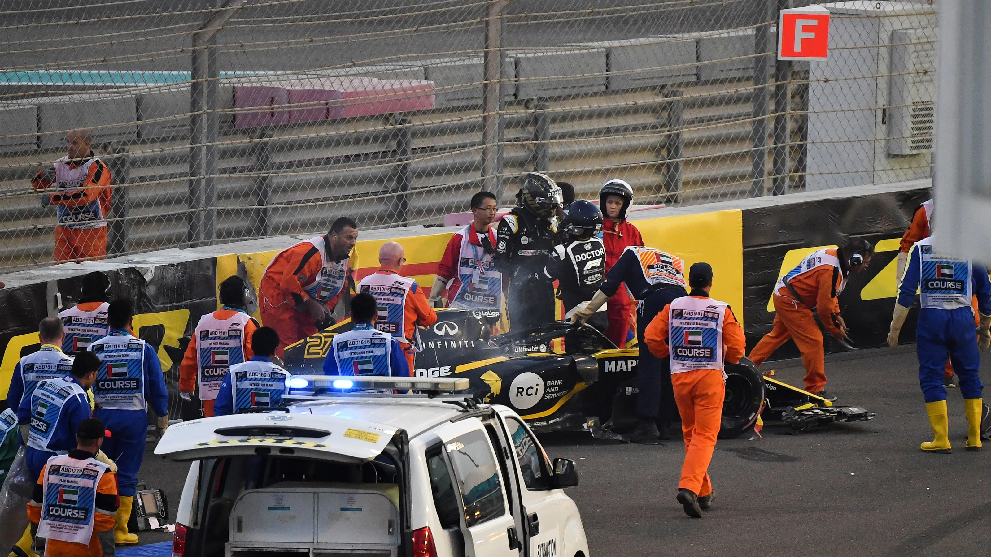 Medics and marshals assist Nico Hulkenberg, Renault Sport F1 Team R.S. 18 who crashed and rolled on