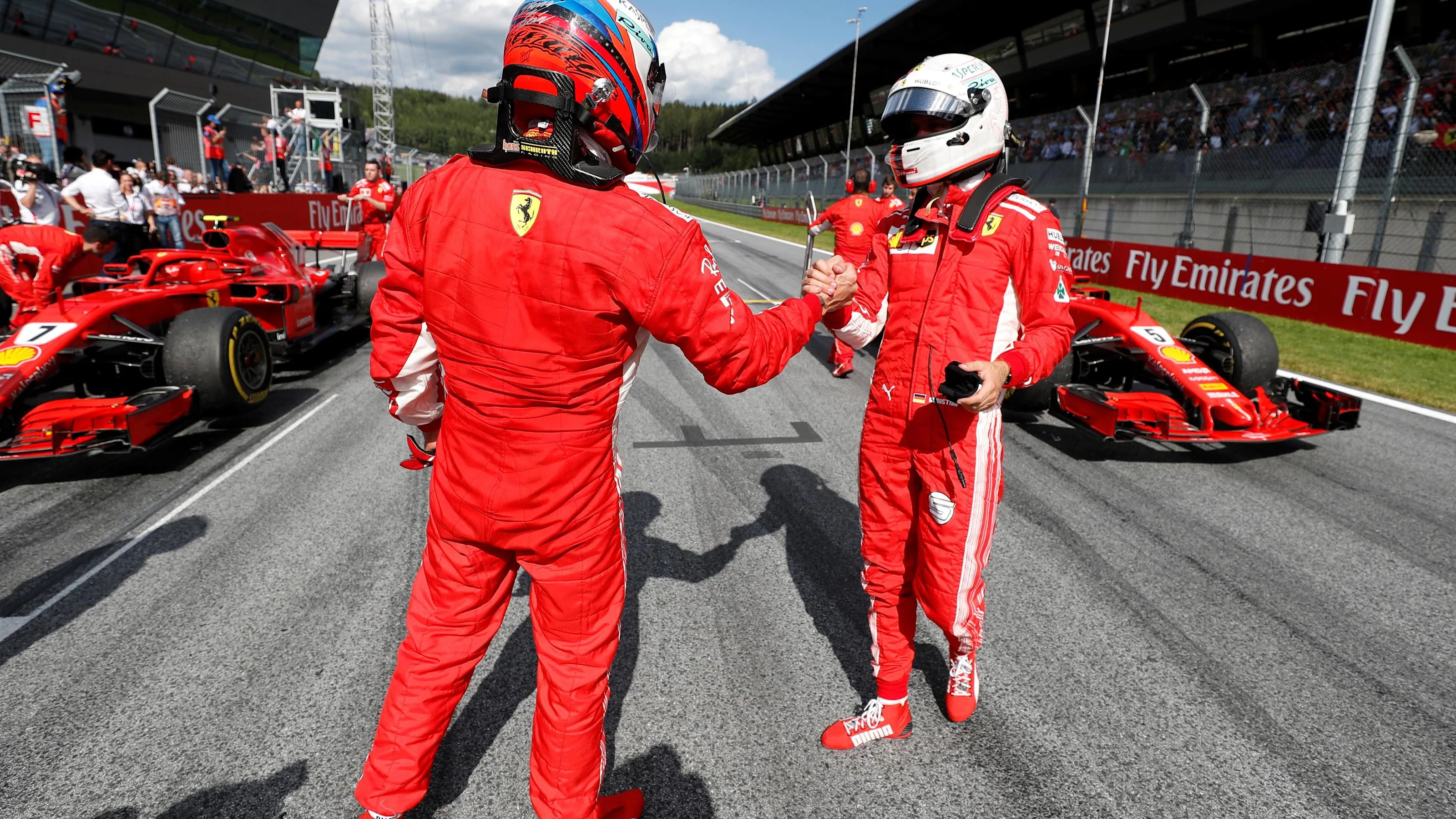 Kimi Raikkonen (FIN) Ferrari and Sebastian Vettel (GER) Ferrari celebrate in parc ferme at Formula
