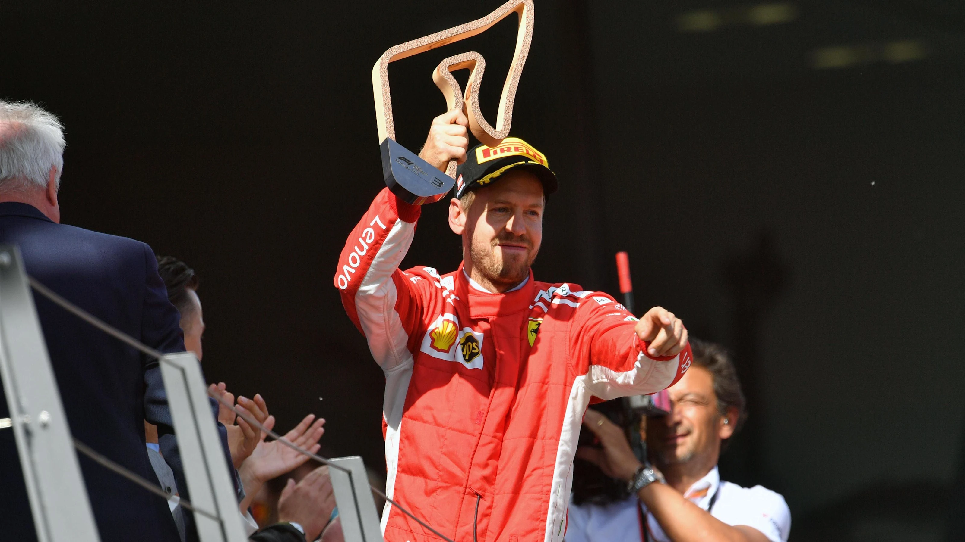 Sebastian Vettel (GER) Ferrari celebrates on the podium with the trophy at Formula One World