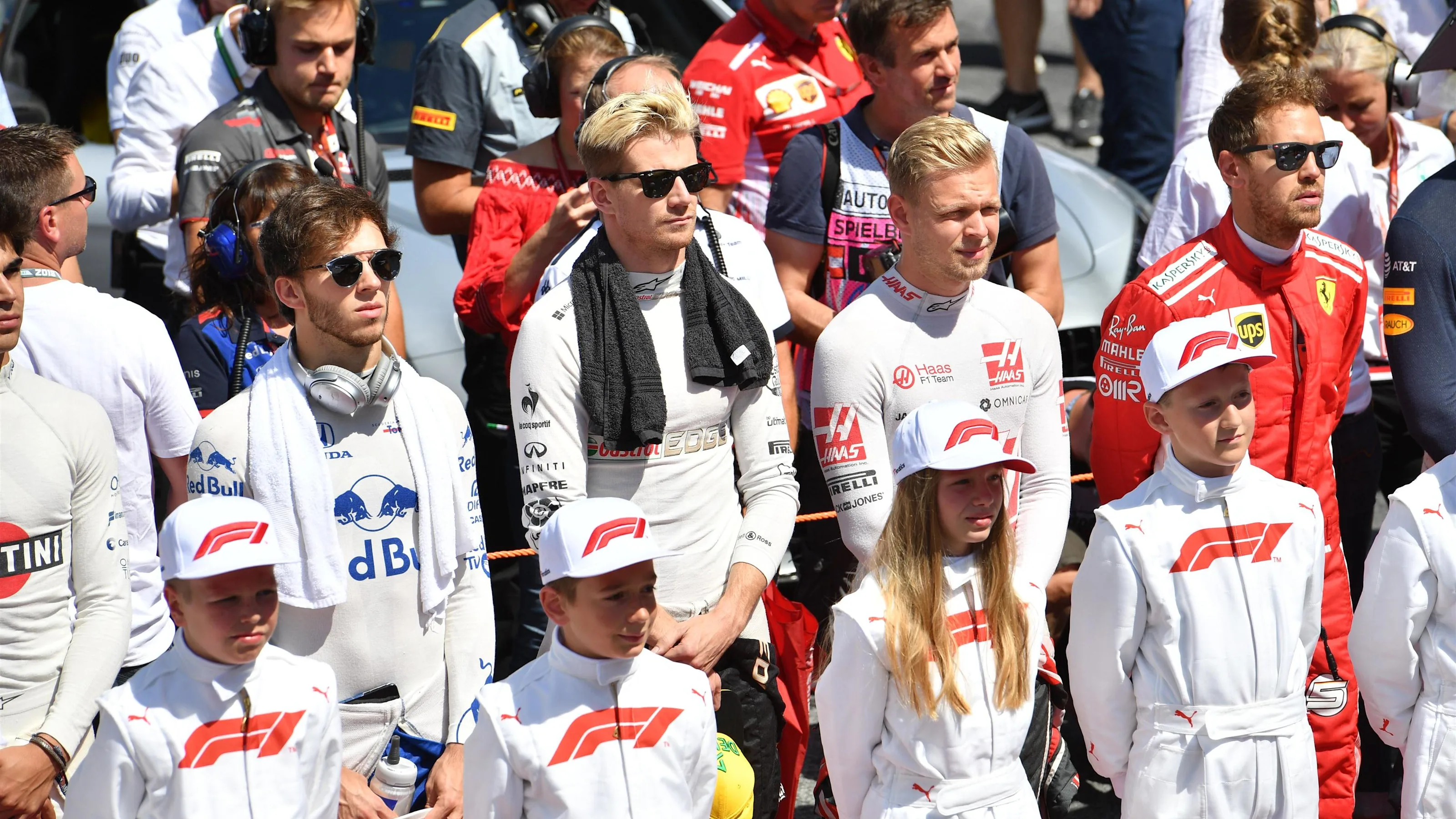 Grid kids and drivers observe the National Anthem on the grid at Formula One World Championship,