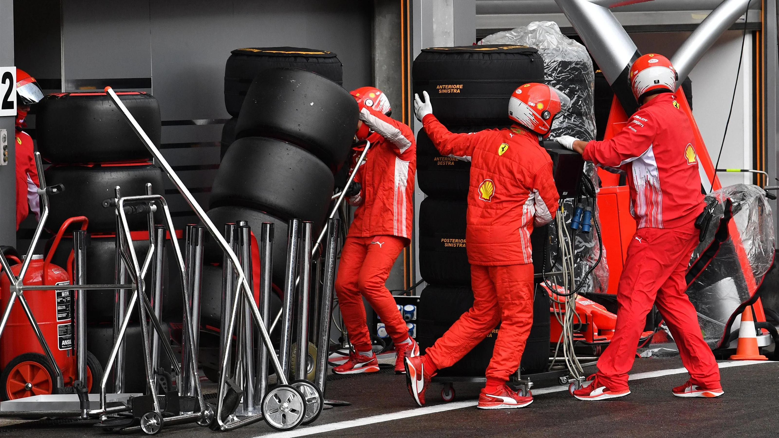 Ferrari mechanics with Pirelli tyres at Formula One World Championship, Rd13, Belgian Grand Prix,