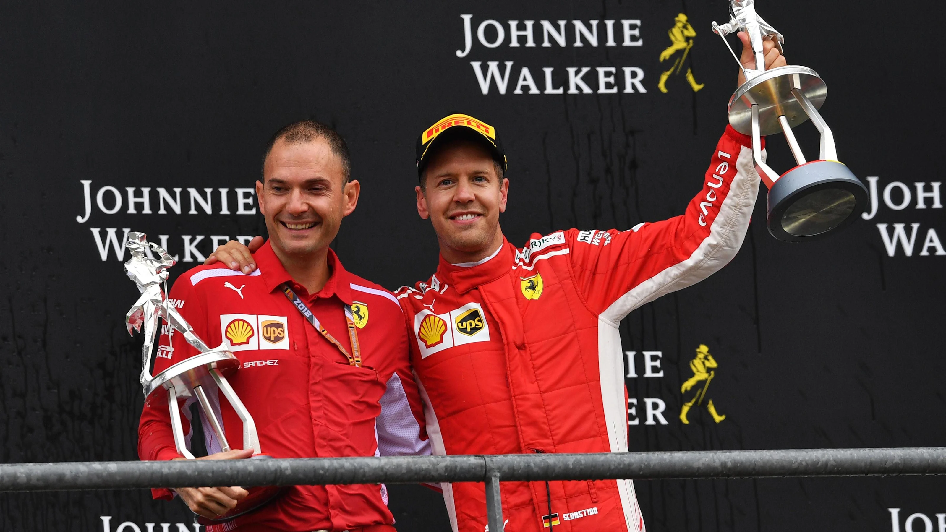 Sebastian Vettel, Ferrari and David Sanchez, Ferrari, celebrates on the podium with the trophies at