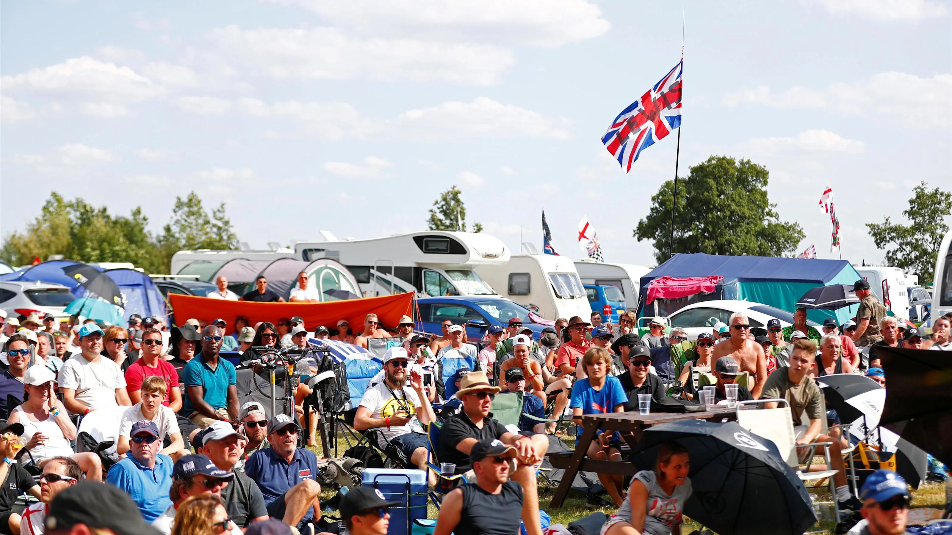 Fans watching football at Formula One World Championship, Rd10, British Grand Prix, Qualifying,