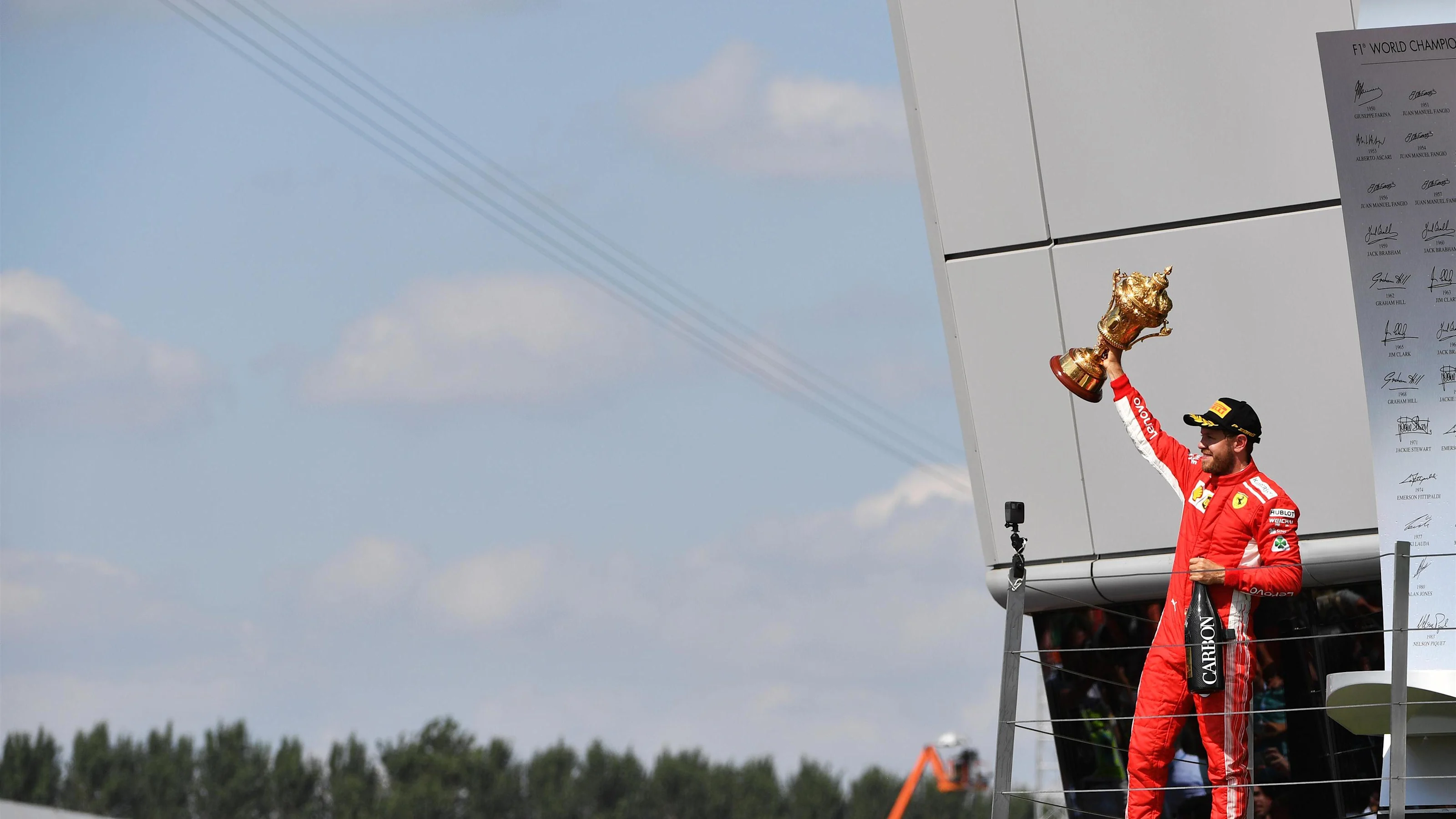 Race winner Sebastian Vettel (GER) Ferrari celebrates on the podium with the trophy at Formula One