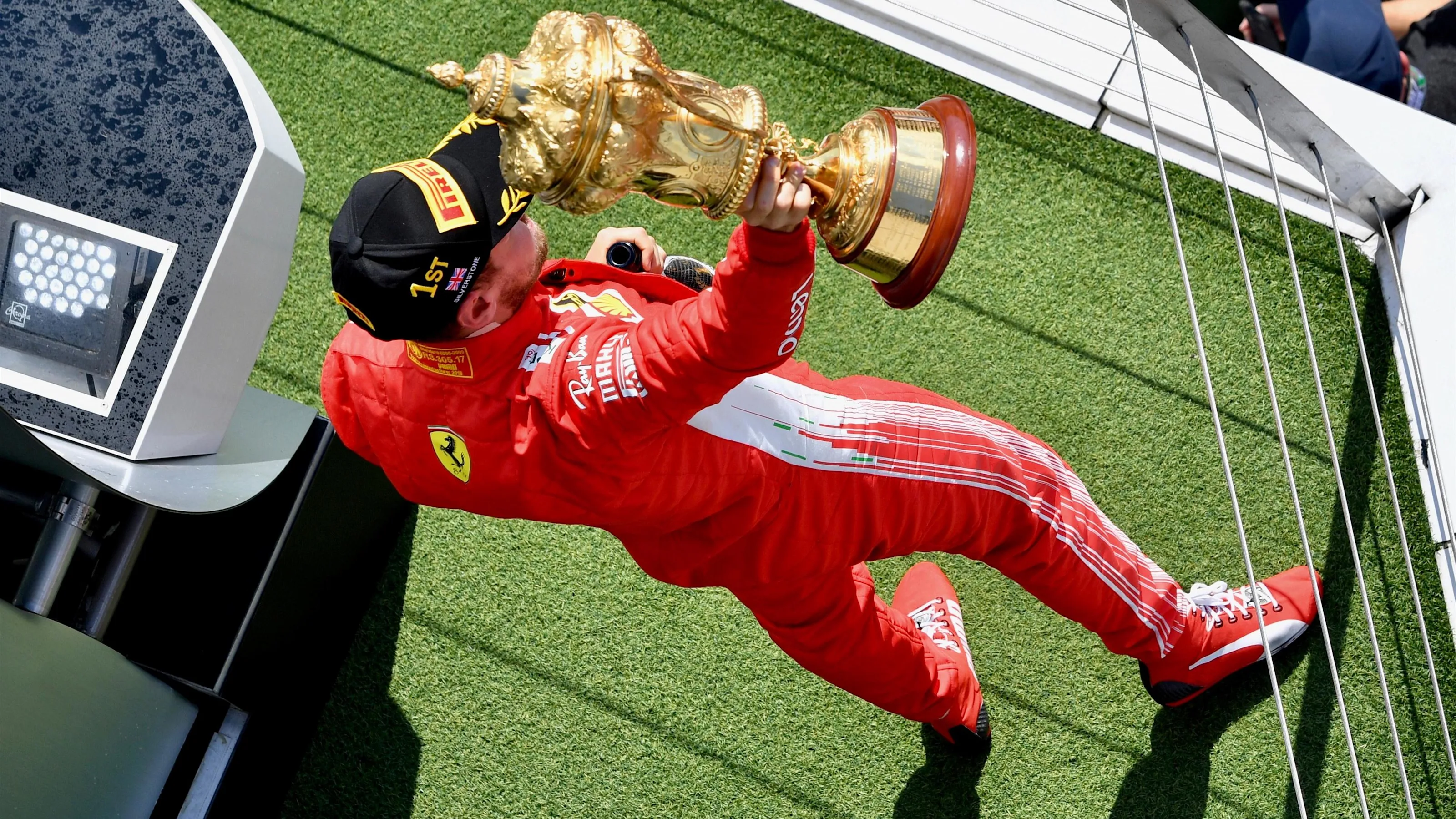 Race winner Sebastian Vettel (GER) Ferrari celebrates on the podium with the trophy at Formula One