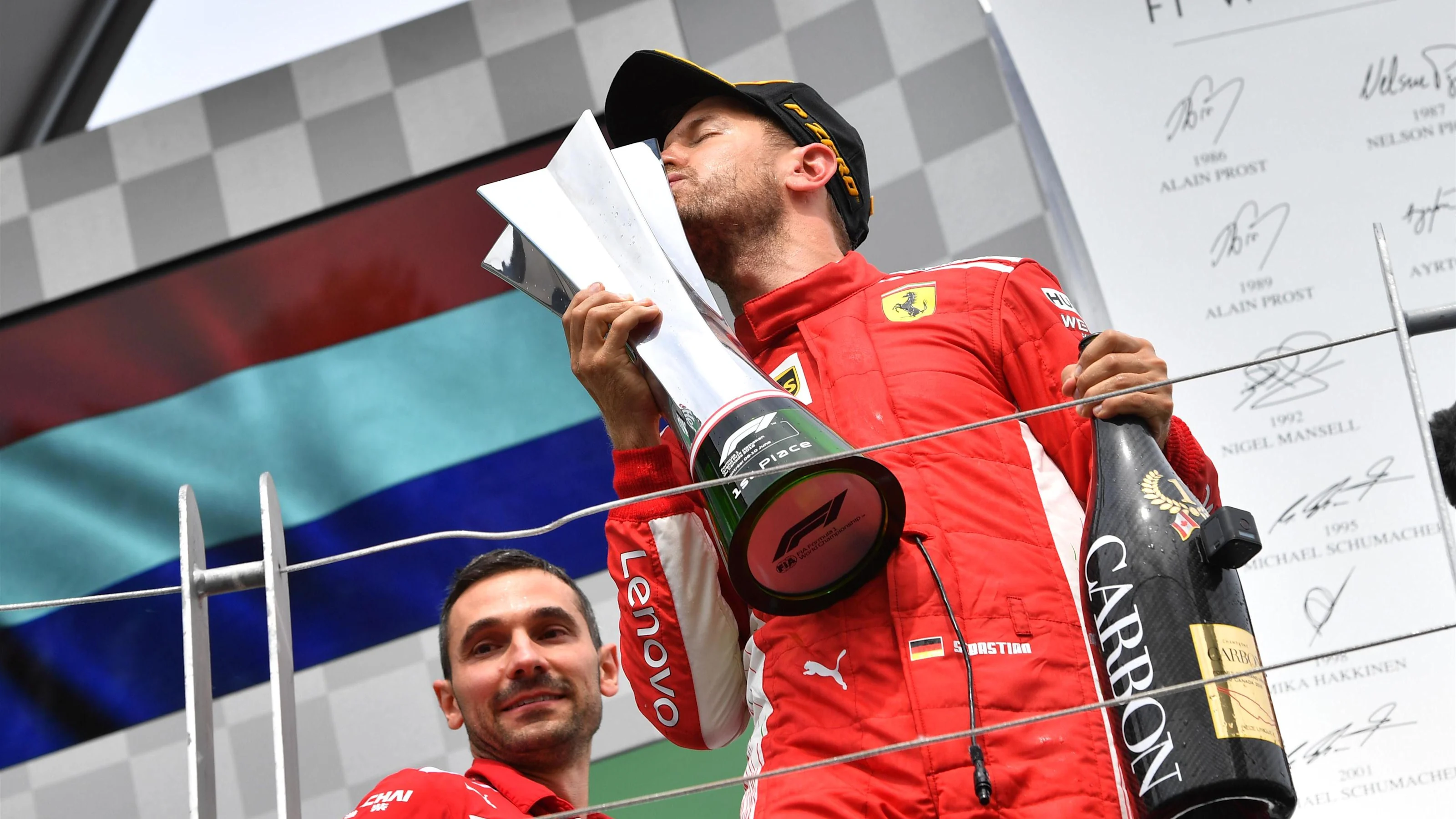 Race winner Sebastian Vettel (GER) Ferrari SF-71H celebrates on the podium and kisses the trophy at