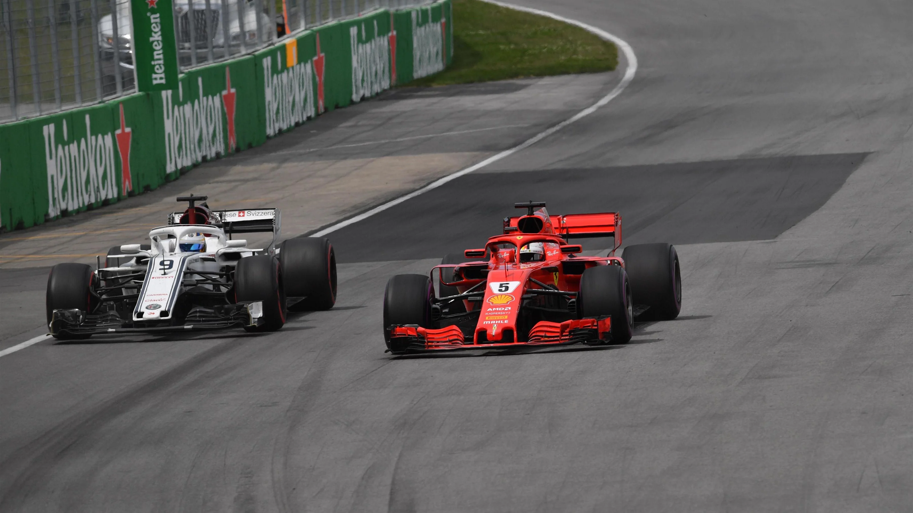Sebastian Vettel (GER) Ferrari SF-71H and Marcus Ericsson (SWE) Alfa Romeo Sauber C37 at Formula