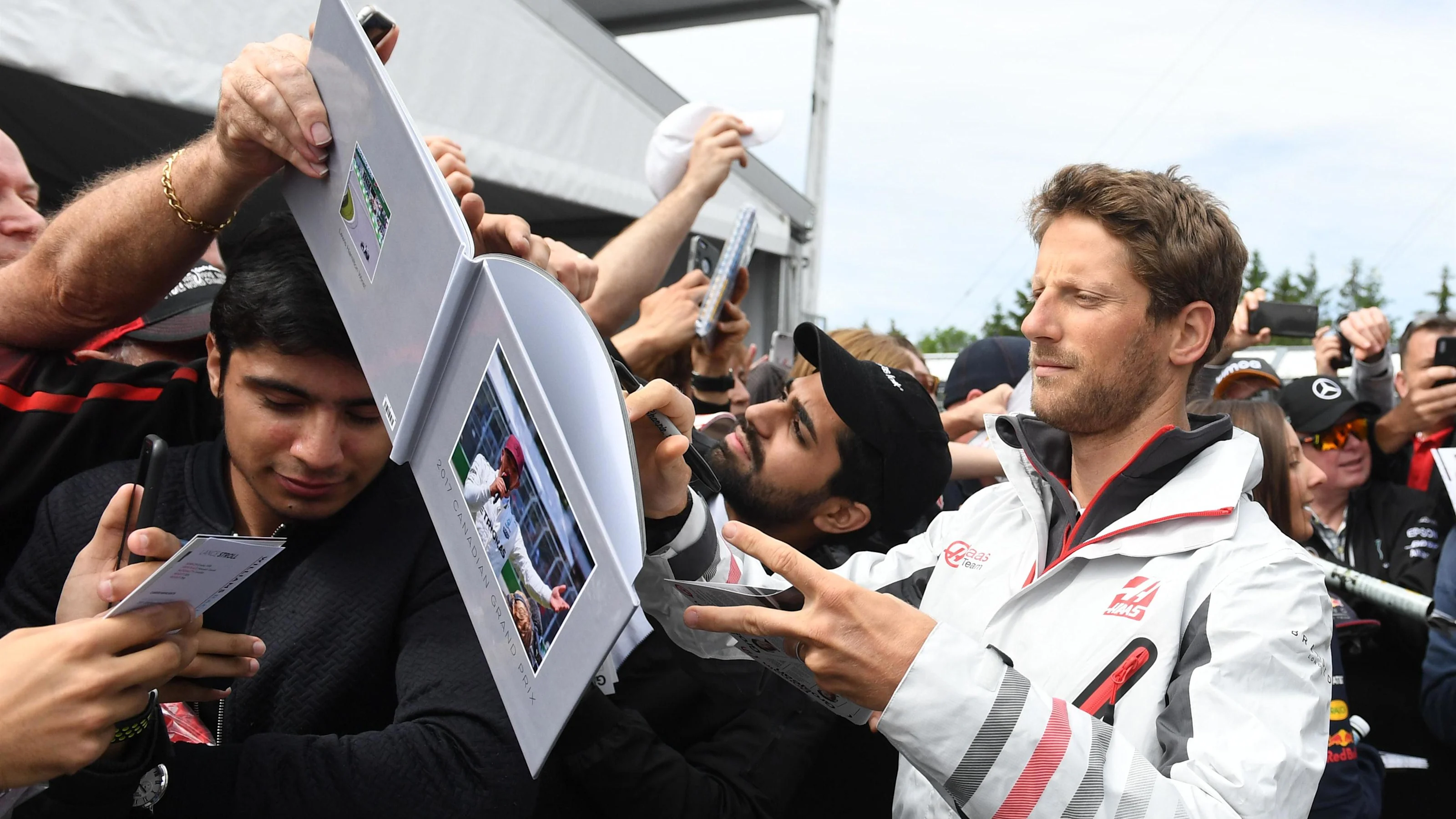 Romain Grosjean (FRA) Haas F1 signs autographs for the fans at Formula One World Championship, Rd7,