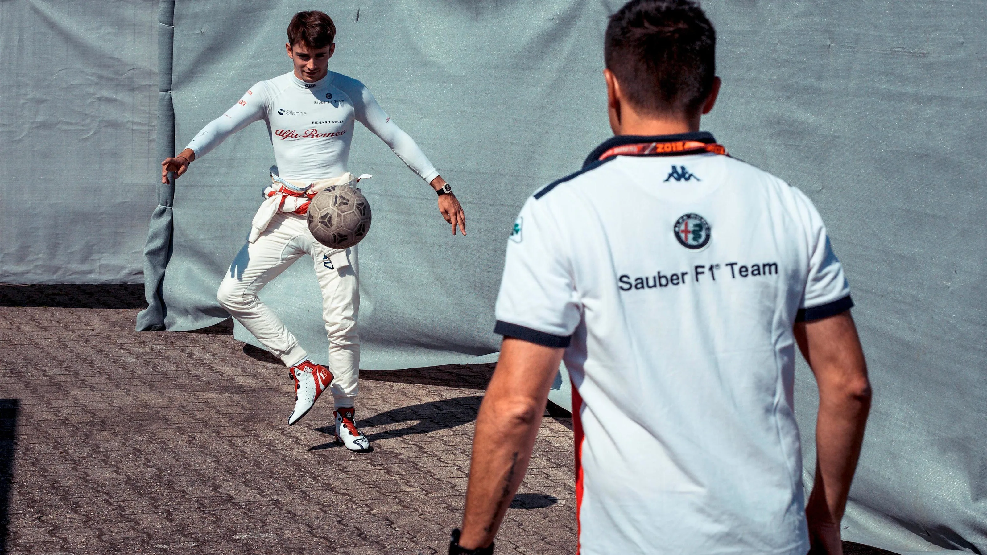 Charles Leclerc (MON) Alfa Romeo Sauber F1 Team warms up playing football with his trainer at