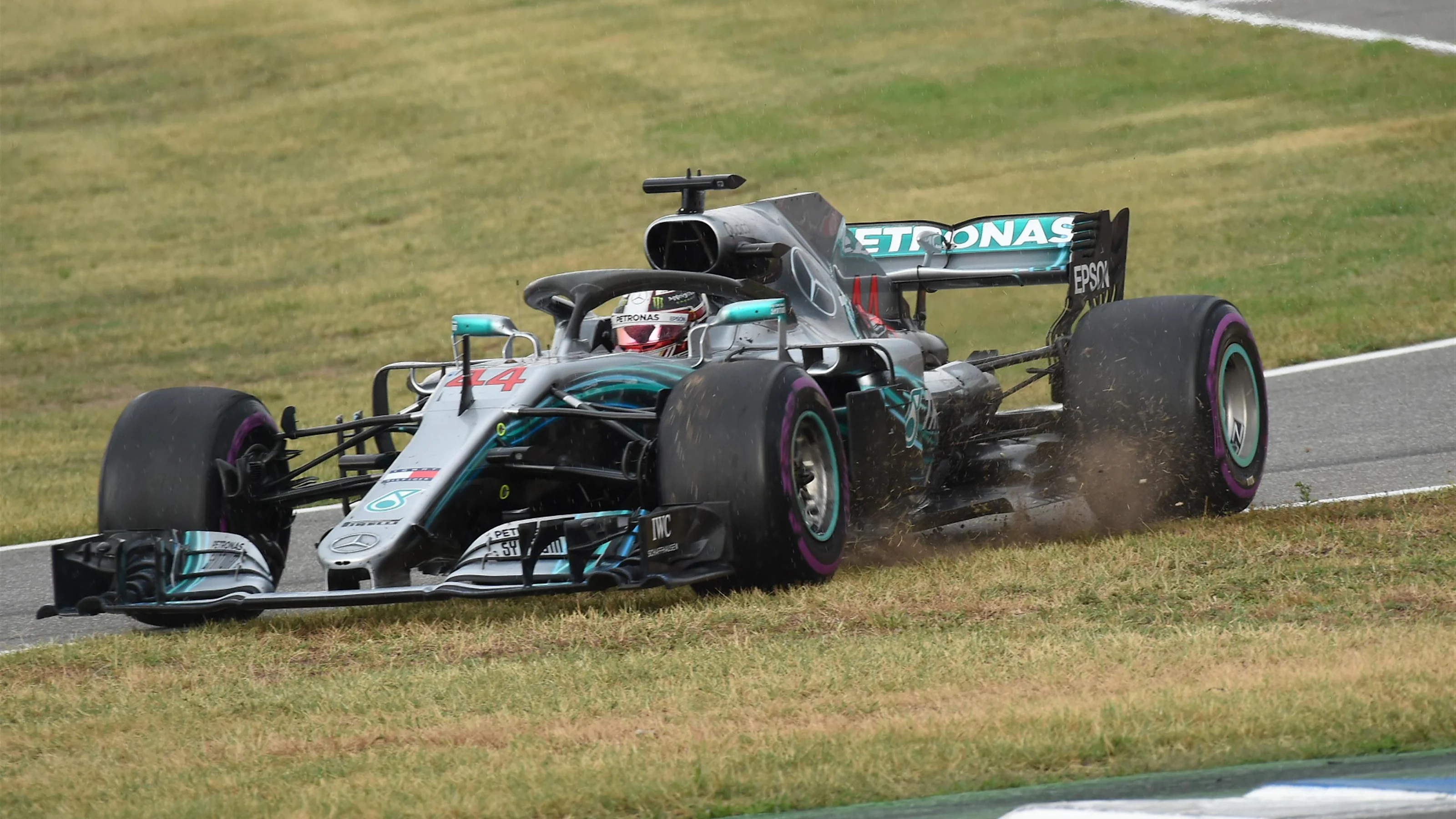 Lewis Hamilton (GBR) Mercedes-AMG F1 W09 EQ Power+ goes across the grass at pit lane entry at